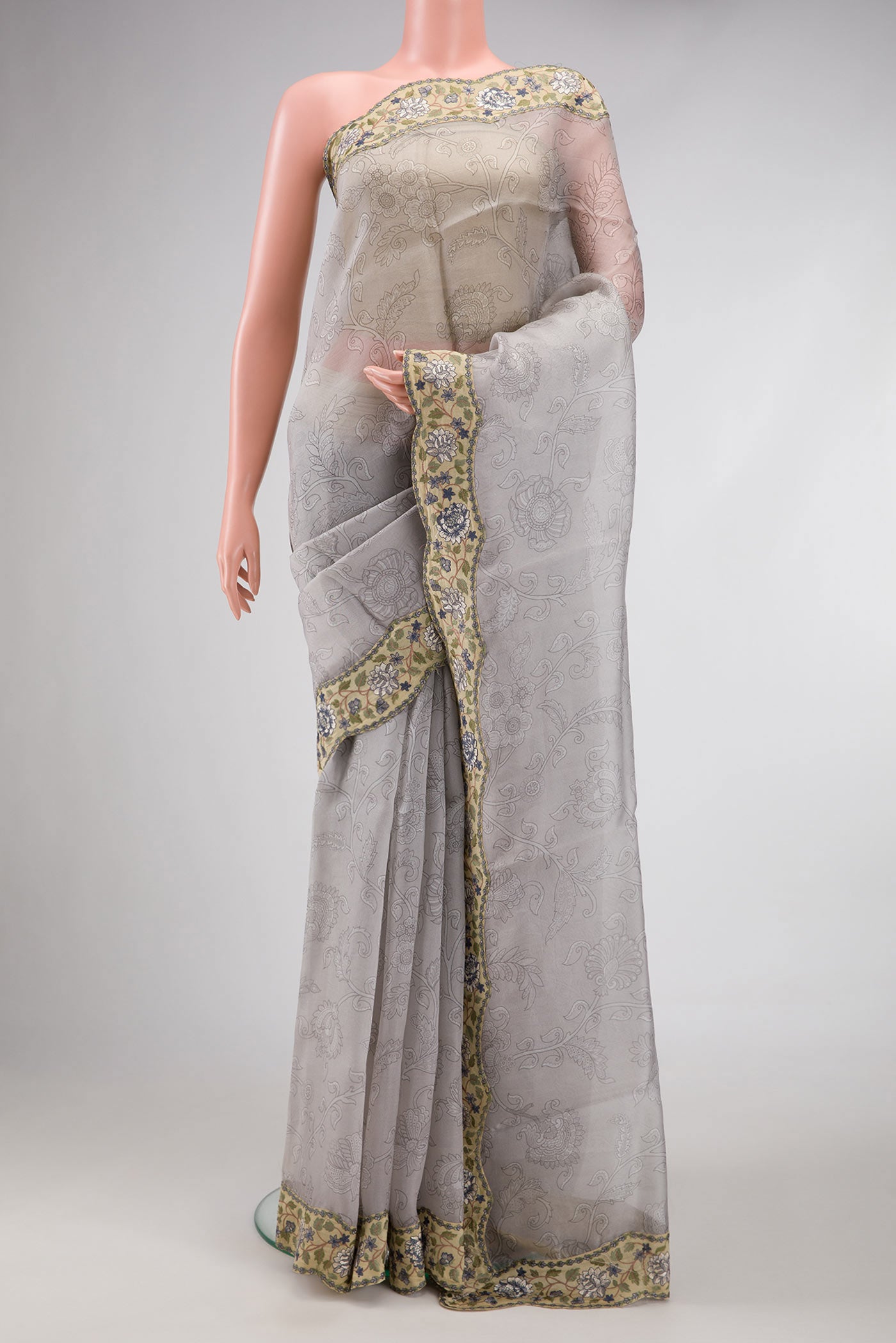Grey Dual Tone Organza Silk Saree with Printed design on the body and Embroidery Border.  displayed on a mannequin