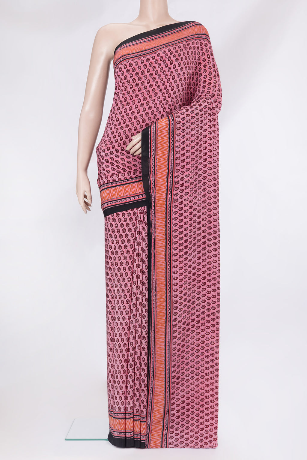 Pink Crepe Saree with Printed design on the body and Printed Border.  displayed on a mannequin