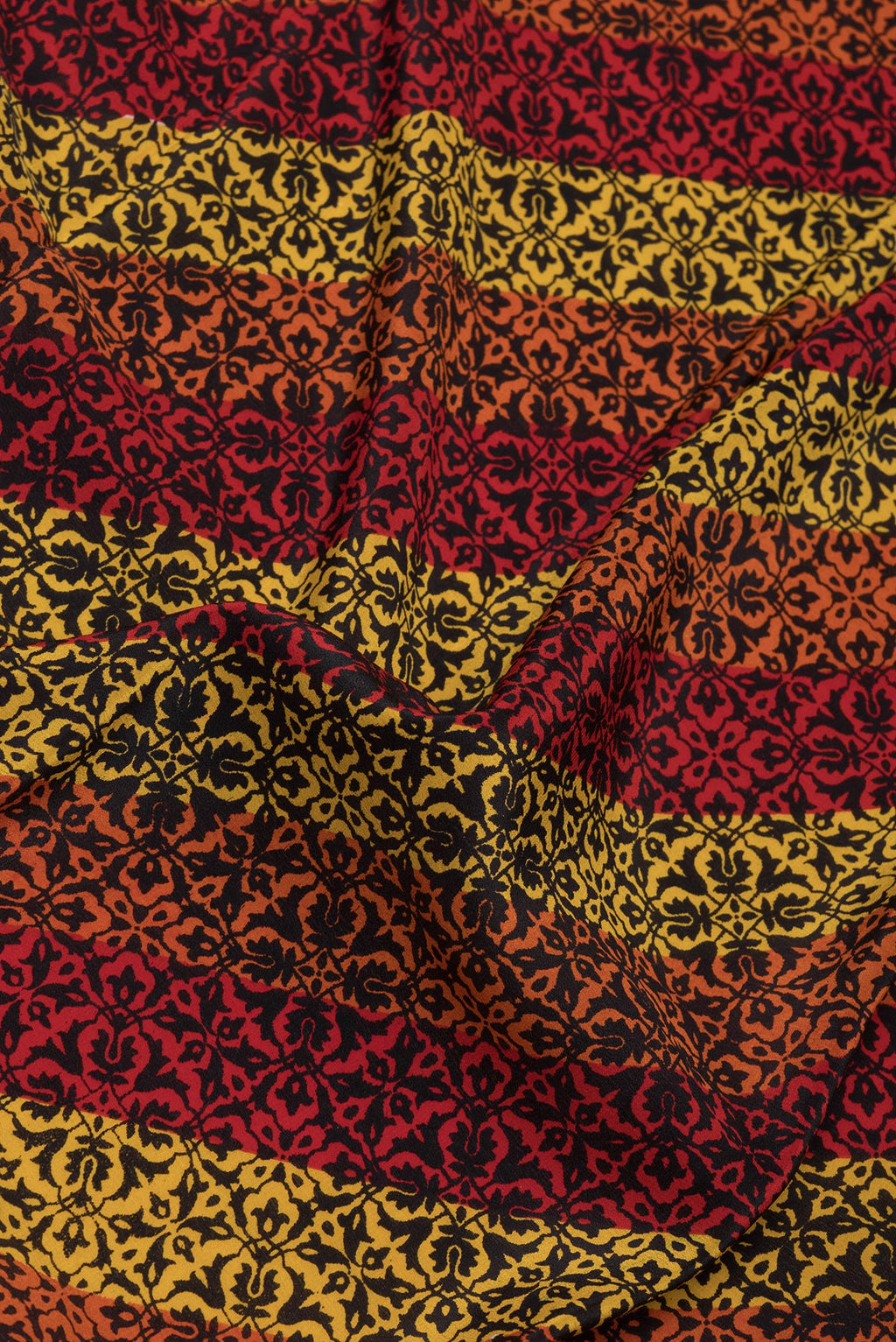 Close up of Multi Color Crepe Saree with Printed design on the body and Printed Border.  displaying folds