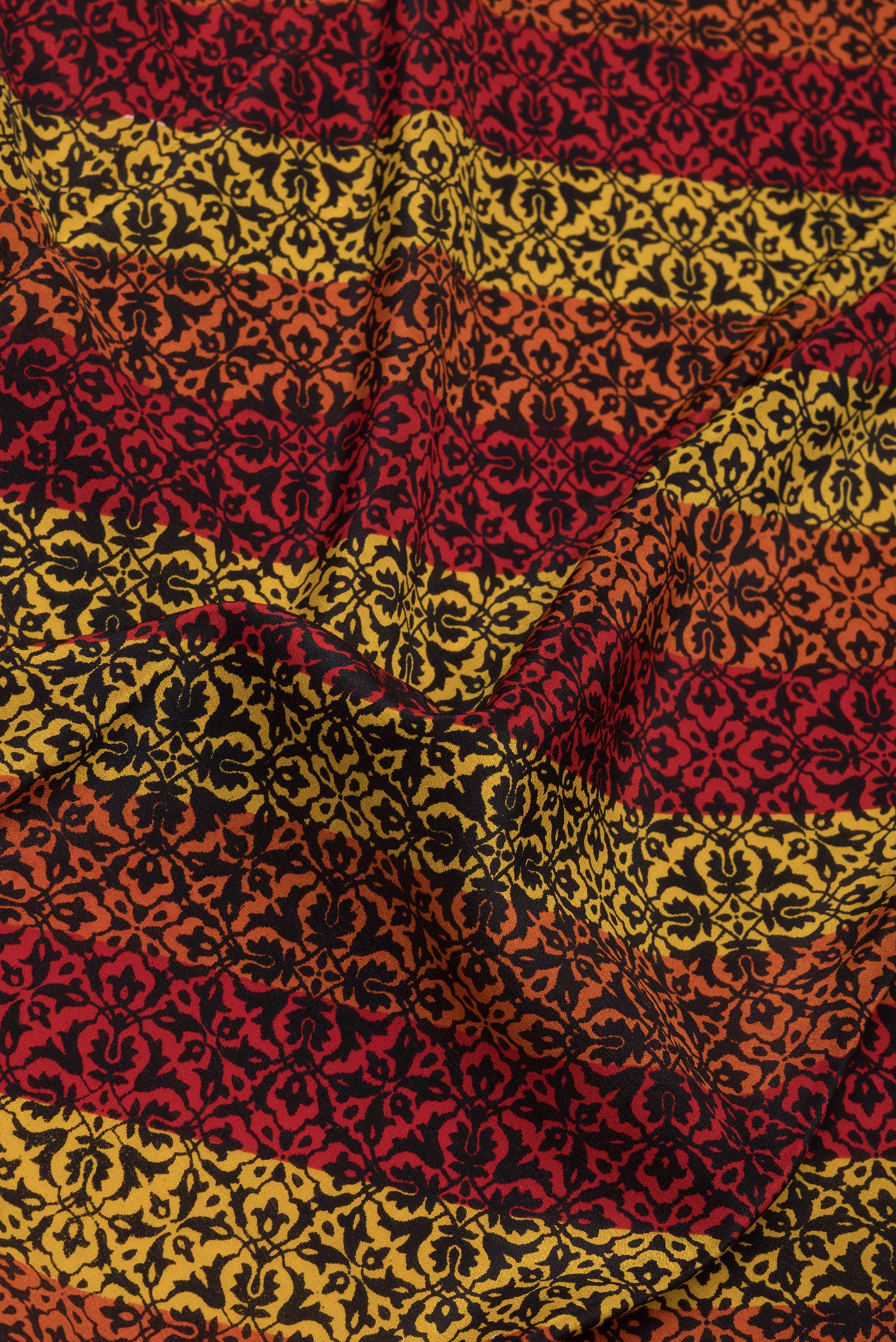 Close up of Multi Color Crepe Saree with Printed design on the body and Printed Border.  displaying folds
