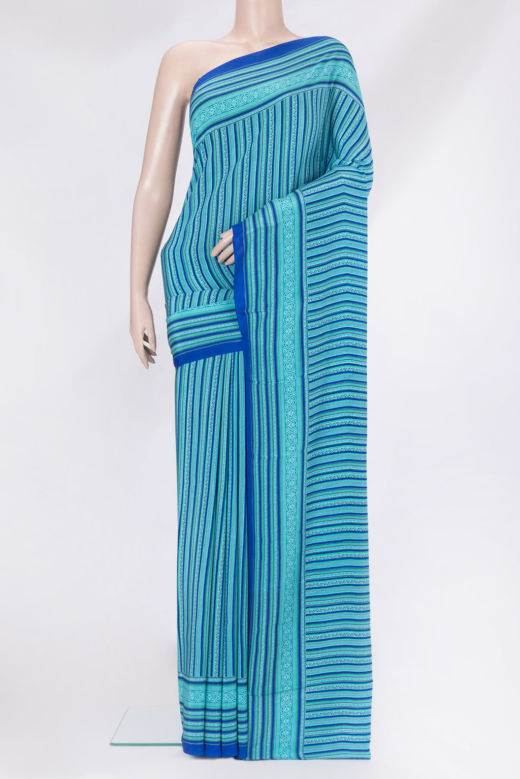 Blue Crepe Saree with Printed design on the body and Printed Border.  displayed on a mannequin