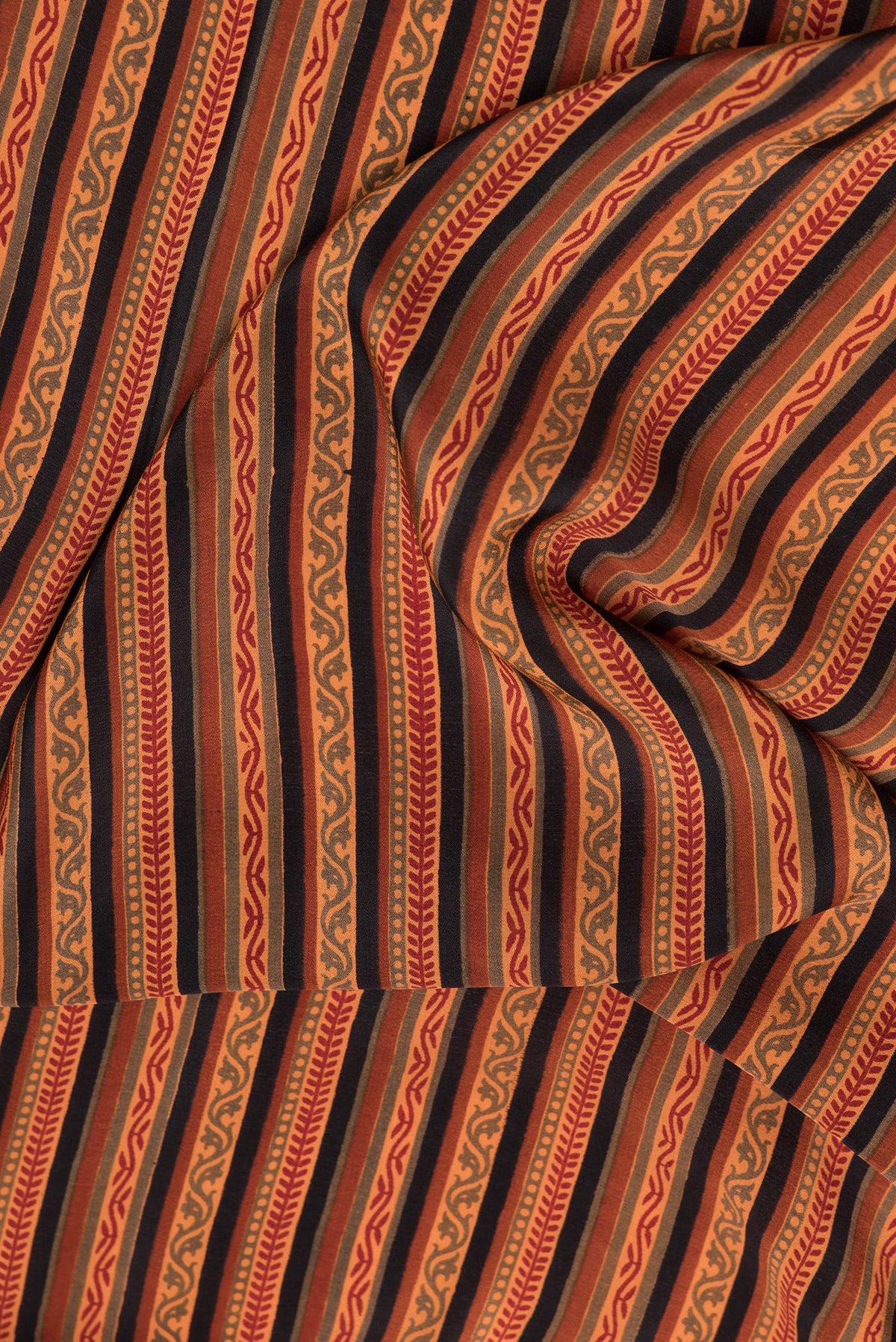 Close up of Black Dual Tone Crepe Saree with Printed design on the body and Printed Border.  displaying folds