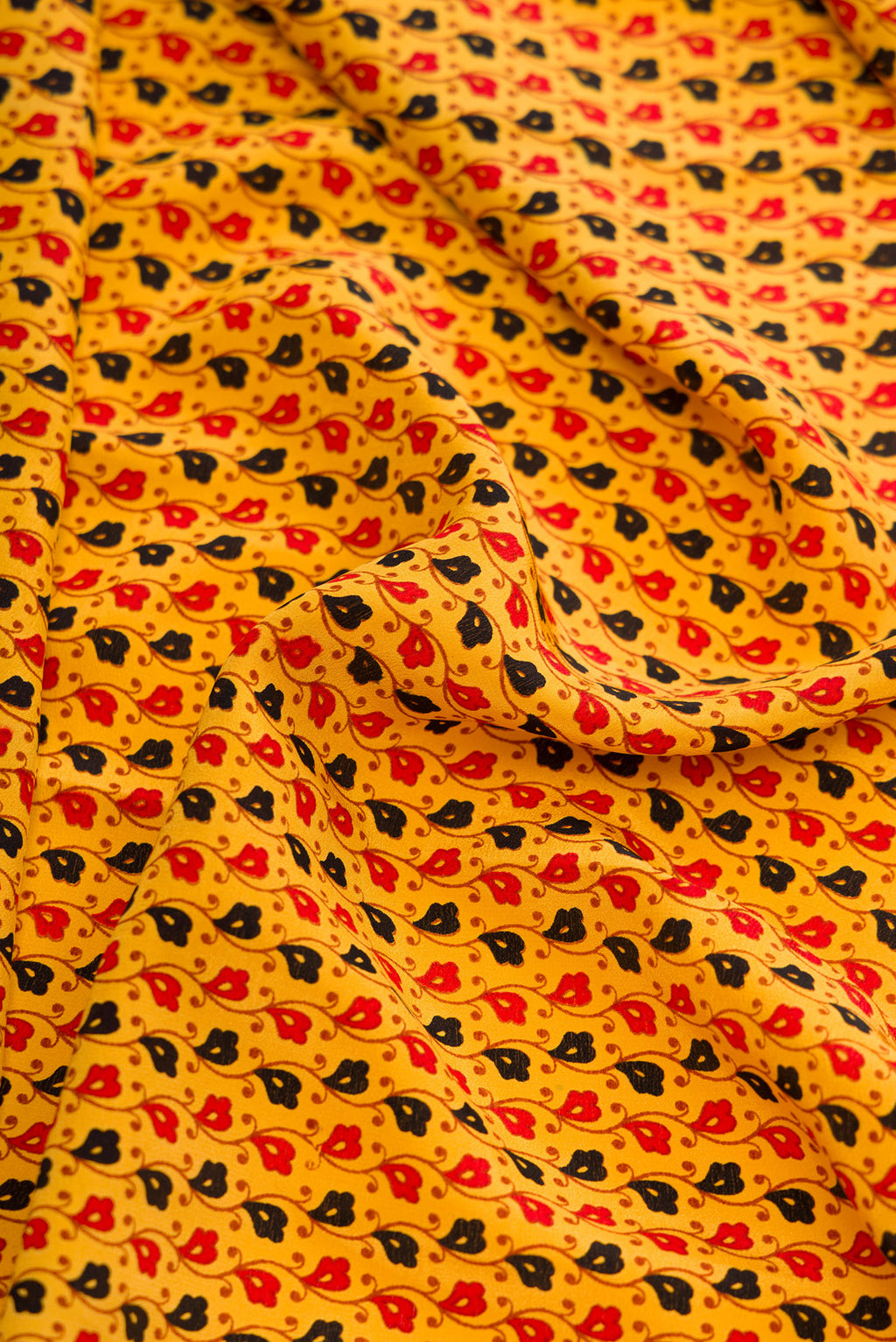 Close up of Yellow Dual Tone Mysore Crepe Saree with Printed design on the body and Printed Border.  displaying folds