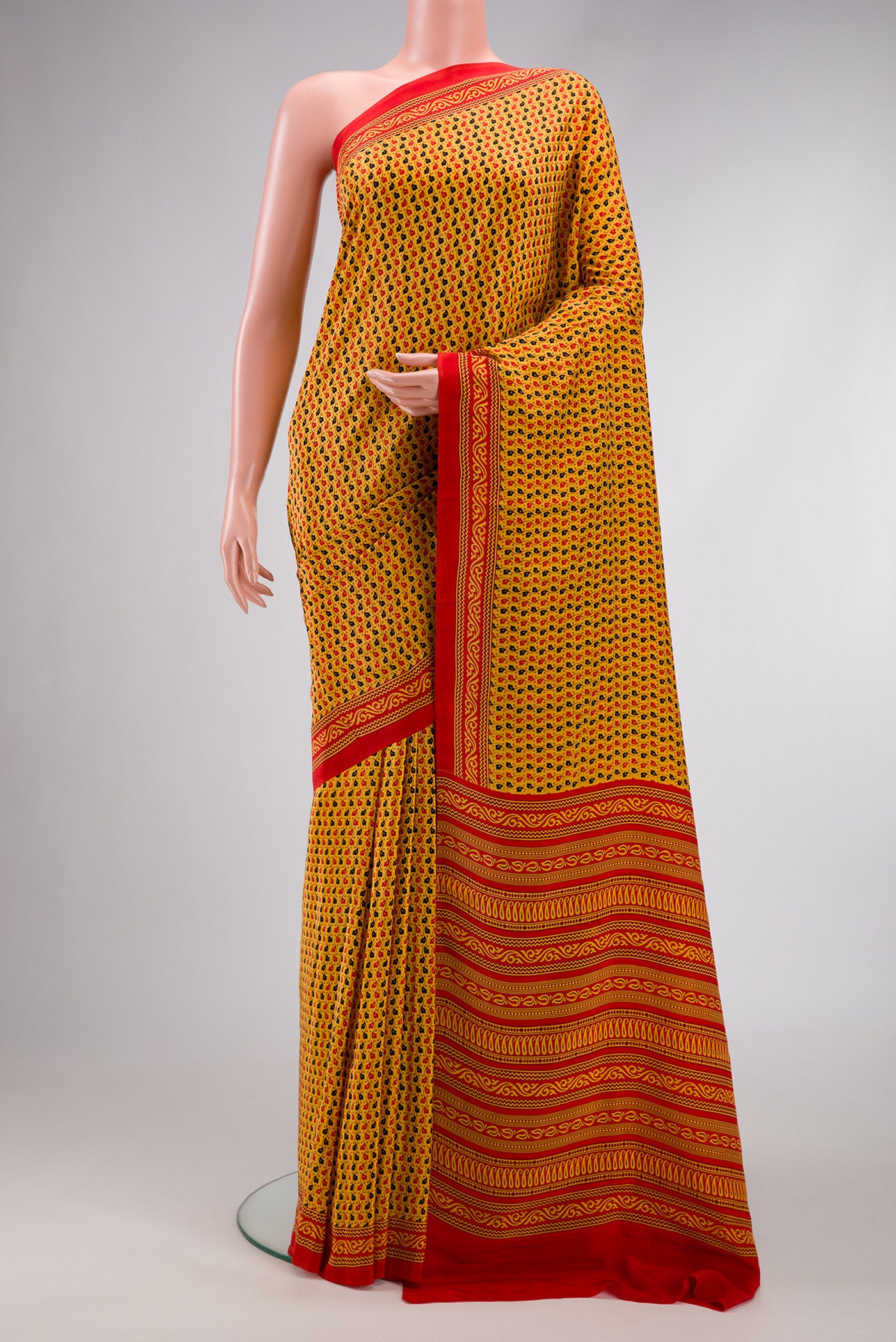 Yellow Dual Tone Mysore Crepe Saree with Printed design on the body and Printed Border.  displayed on a mannequin