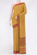 Yellow Crepe Saree with Printed design on the body and Printed Border.  displayed on a mannequin