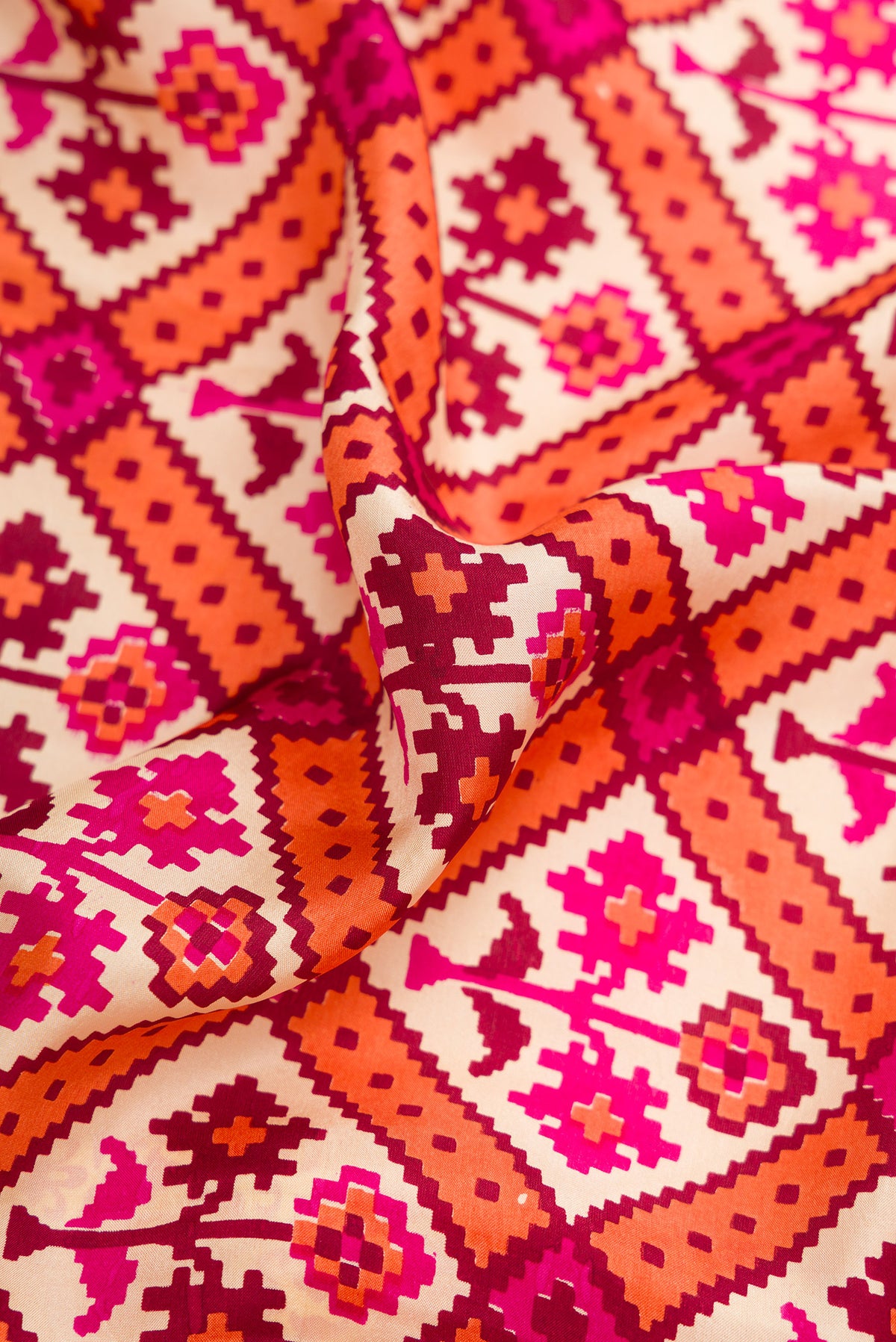 Close up of Sandal Dual Tone Mysore Crepe Saree with Printed design on the body and Printed Border.  displaying folds