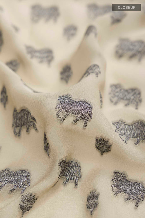 Close up of Beige Banarasi Georgette Saree with Zari Butta on the body and Zari Border displaying folds