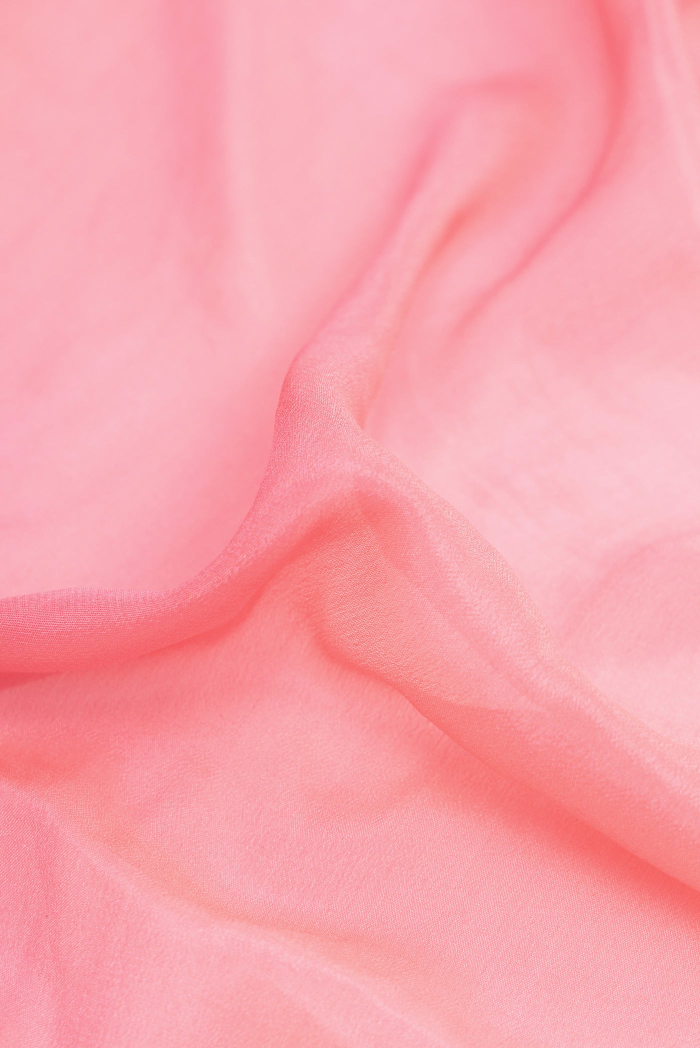 Close up of Pink Dual Tone Mysore Georgette Saree with Plain Body and Thread Border.  displaying folds