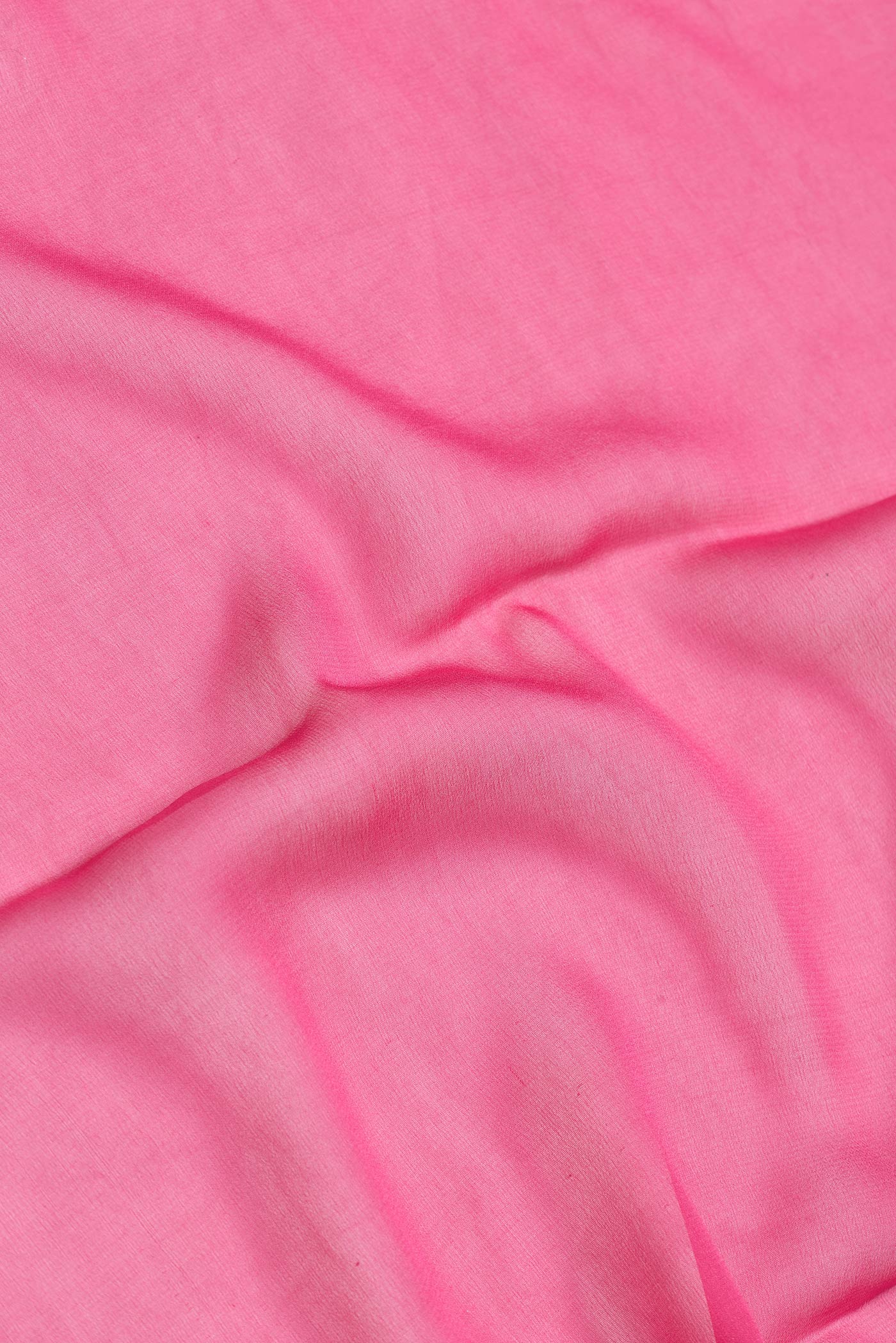 Close up of Pink Dual Tone Mysore Georgette Saree with Plain Body and Zari Border.  displaying folds