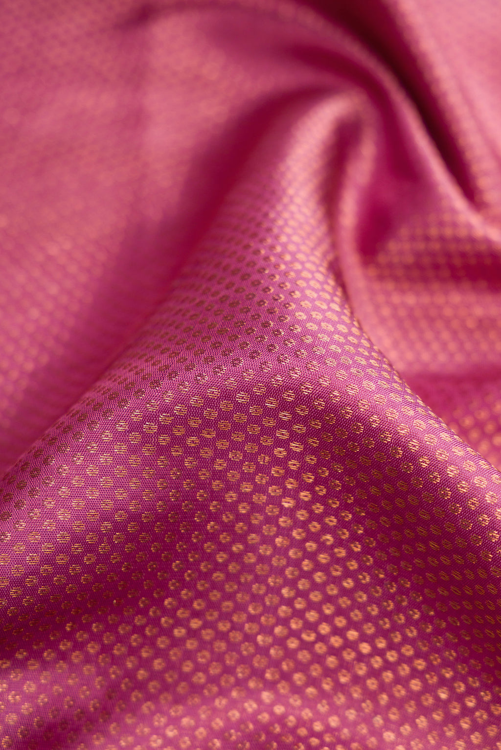 Close up of Pink Dual Tone Kanjivaram Silk Saree with Zari Brocade on the body and Fancy Border.  displaying folds
