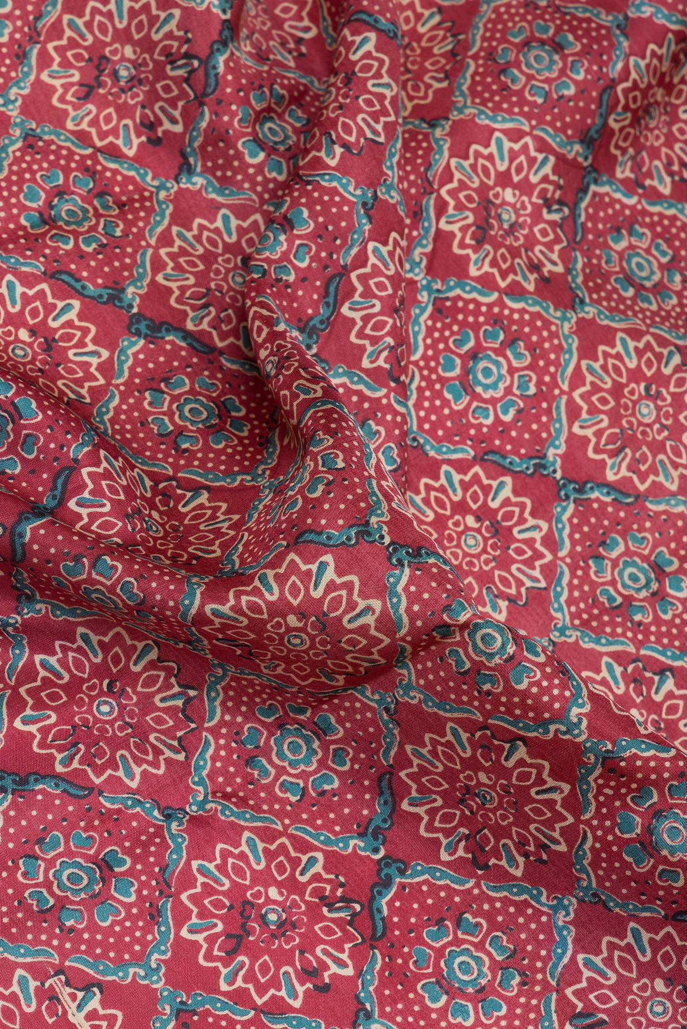 Close up of Maroon Dual Tone Kanjivaram Silk Saree with Printed design on the body and Zari Border.  displaying folds