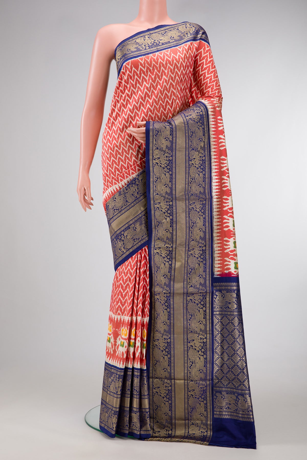 Maroon Dual Tone Double Ikat Saree with Ikat Print on the body and Zari Border.  displayed on a mannequin