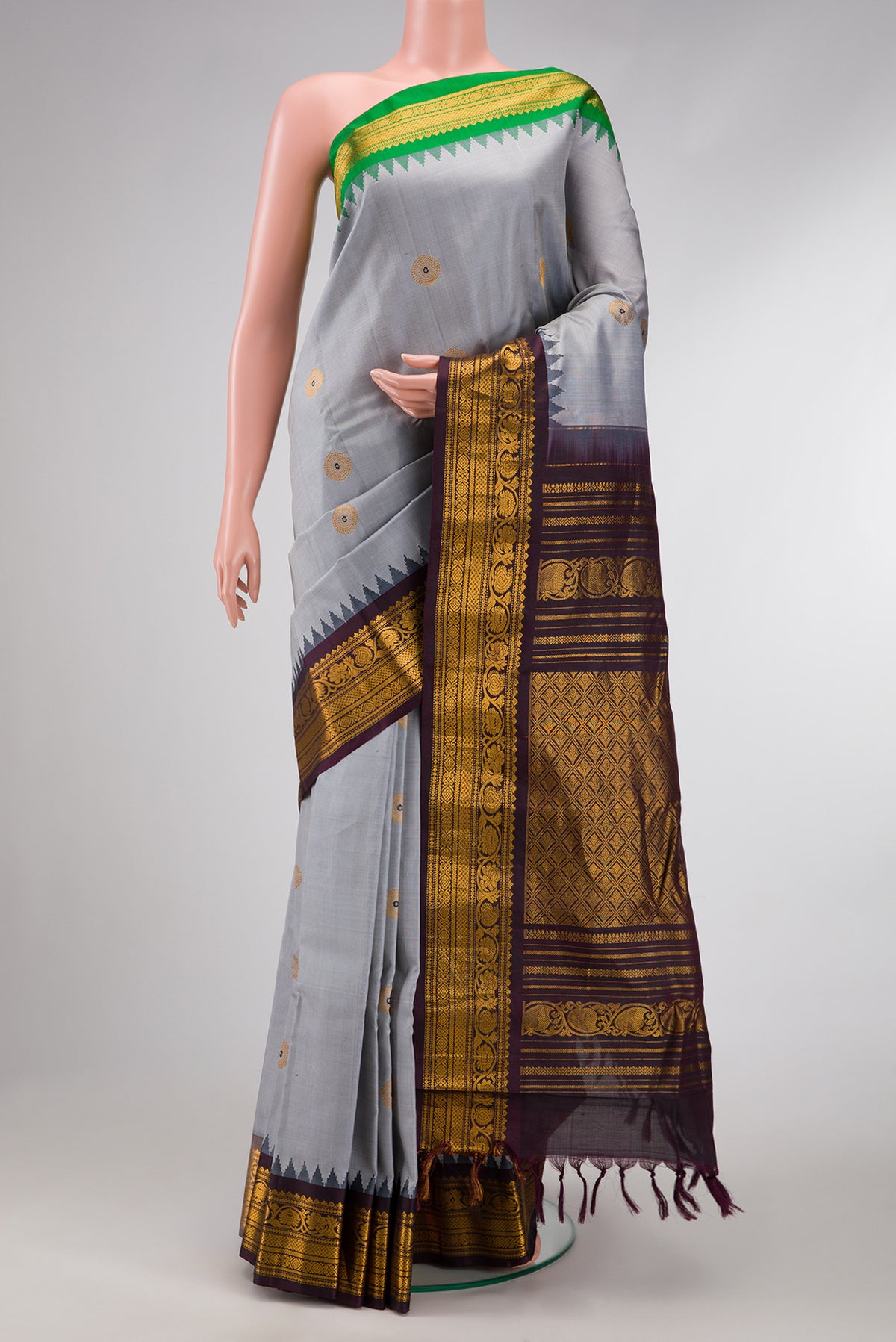Grey Dual Tone Gadwal Silk Saree with Zari And Thread Butta on the body and Ganga Jamuna Border.  displayed on a mannequin