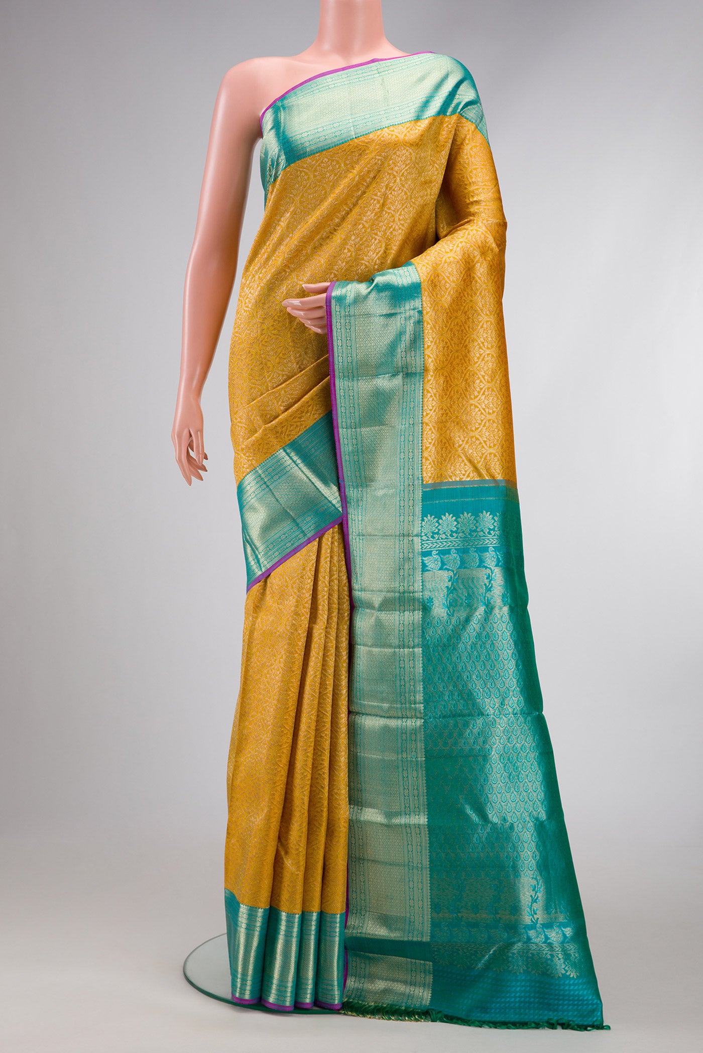 Mustard Dual Tone Kanchipuram Silk Saree with Zari Brocade on the body and Zari Border.  displayed on a mannequin
