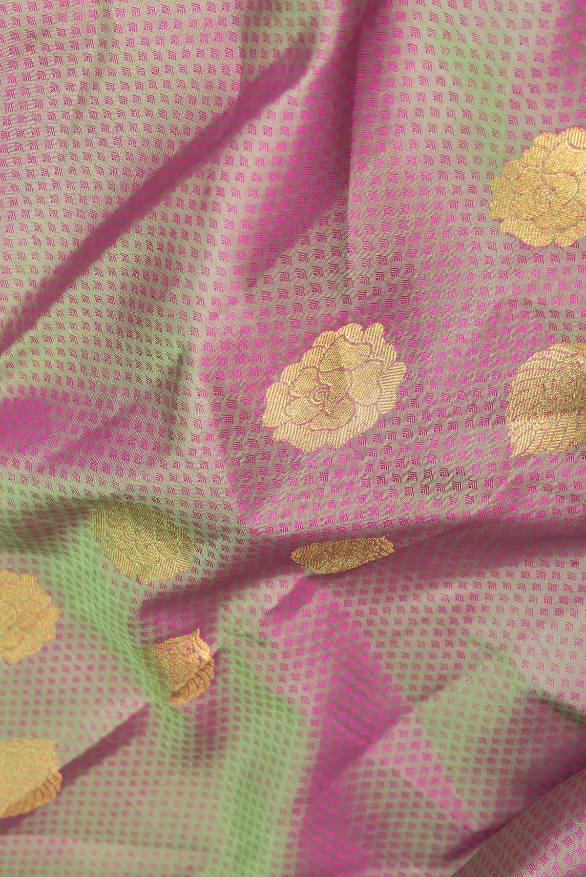Close up of Light Green Dual Tone Kanchipuram Silk Saree with Jacquard With Zari Butta on the body and Zari Border displaying folds