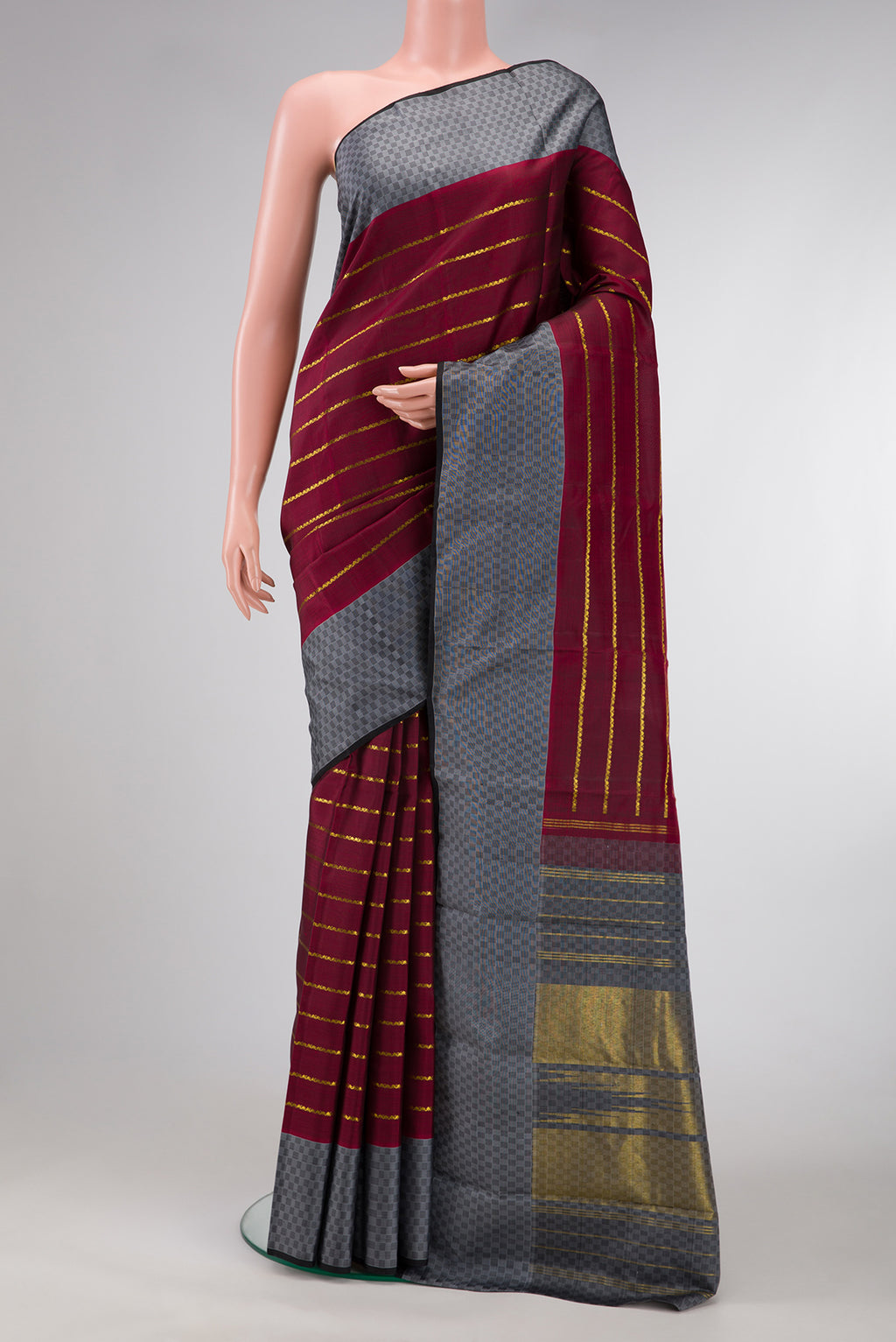 Maroon Dual Tone Kanchipuram Silk Saree with Stripes on the body and Checks Border.  displayed on a mannequin