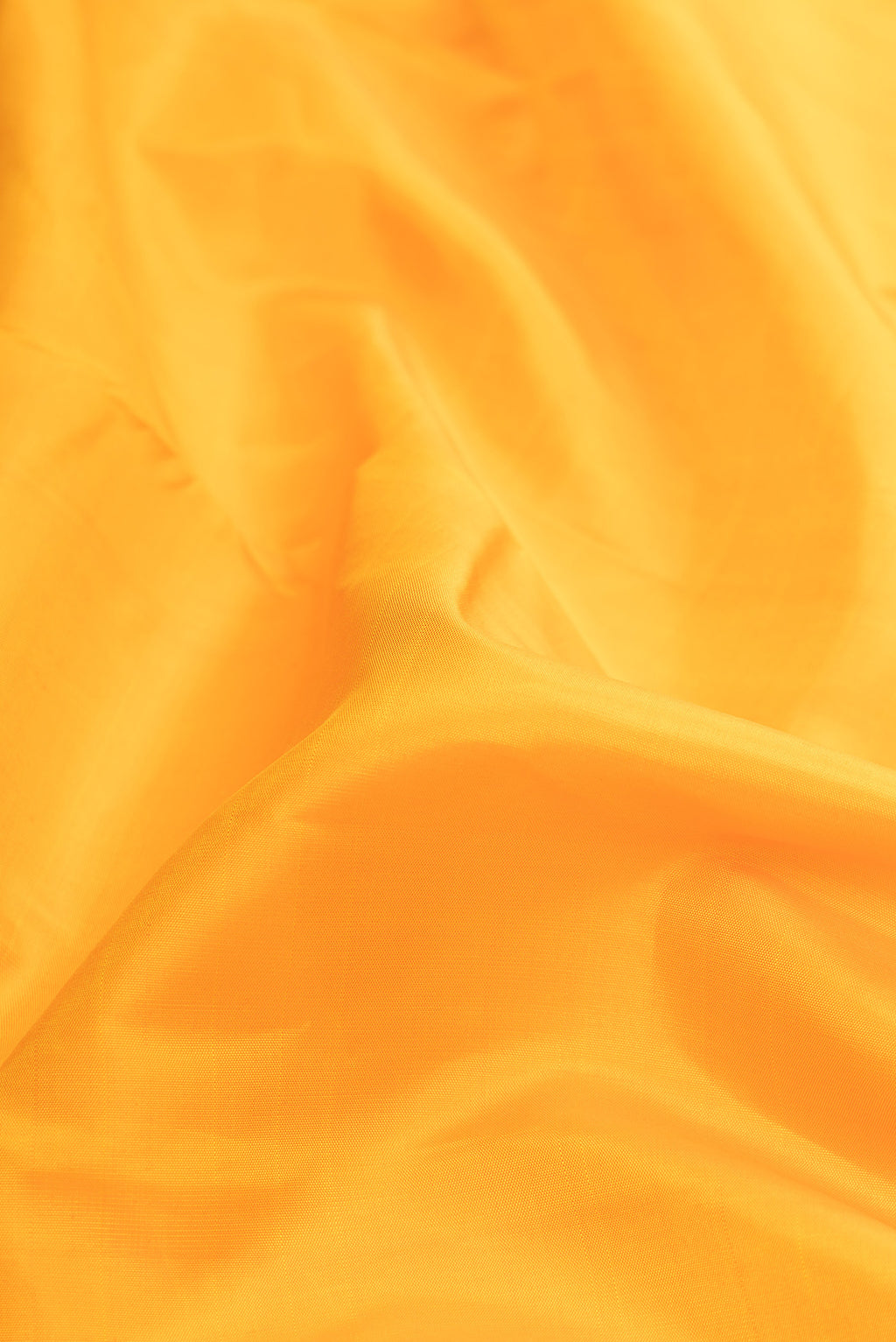 Close up of Pure Silk Pure Zari Mustard Dual Tone Kanjivaram Saree with Plain Body and Zari Border.  displaying folds
