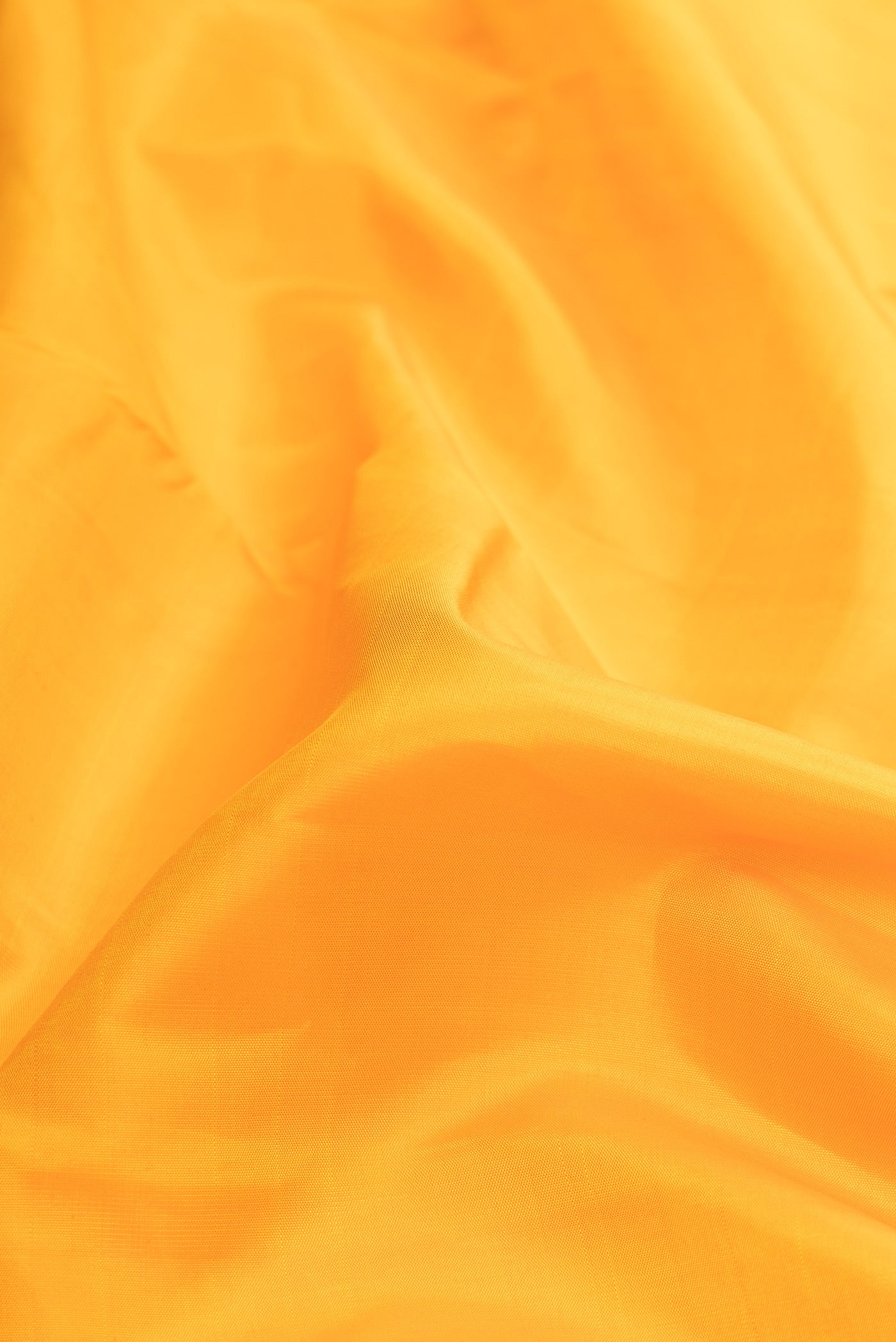 Close up of Pure Silk Pure Zari Mustard Dual Tone Kanjivaram Saree with Plain Body and Zari Border.  displaying folds