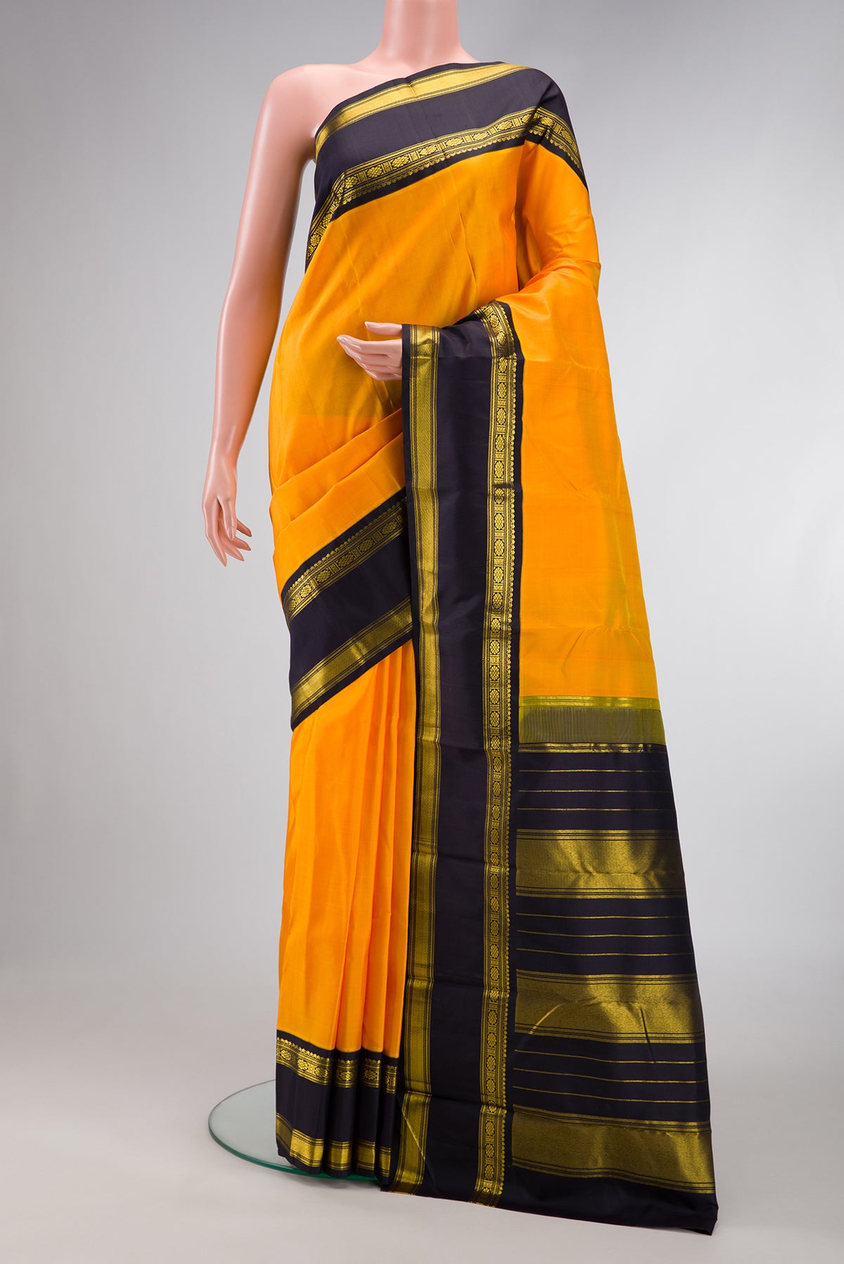 Pure Silk Pure Zari Mustard Dual Tone Kanjivaram Saree with Plain Body and Zari Border.  displayed on a mannequin