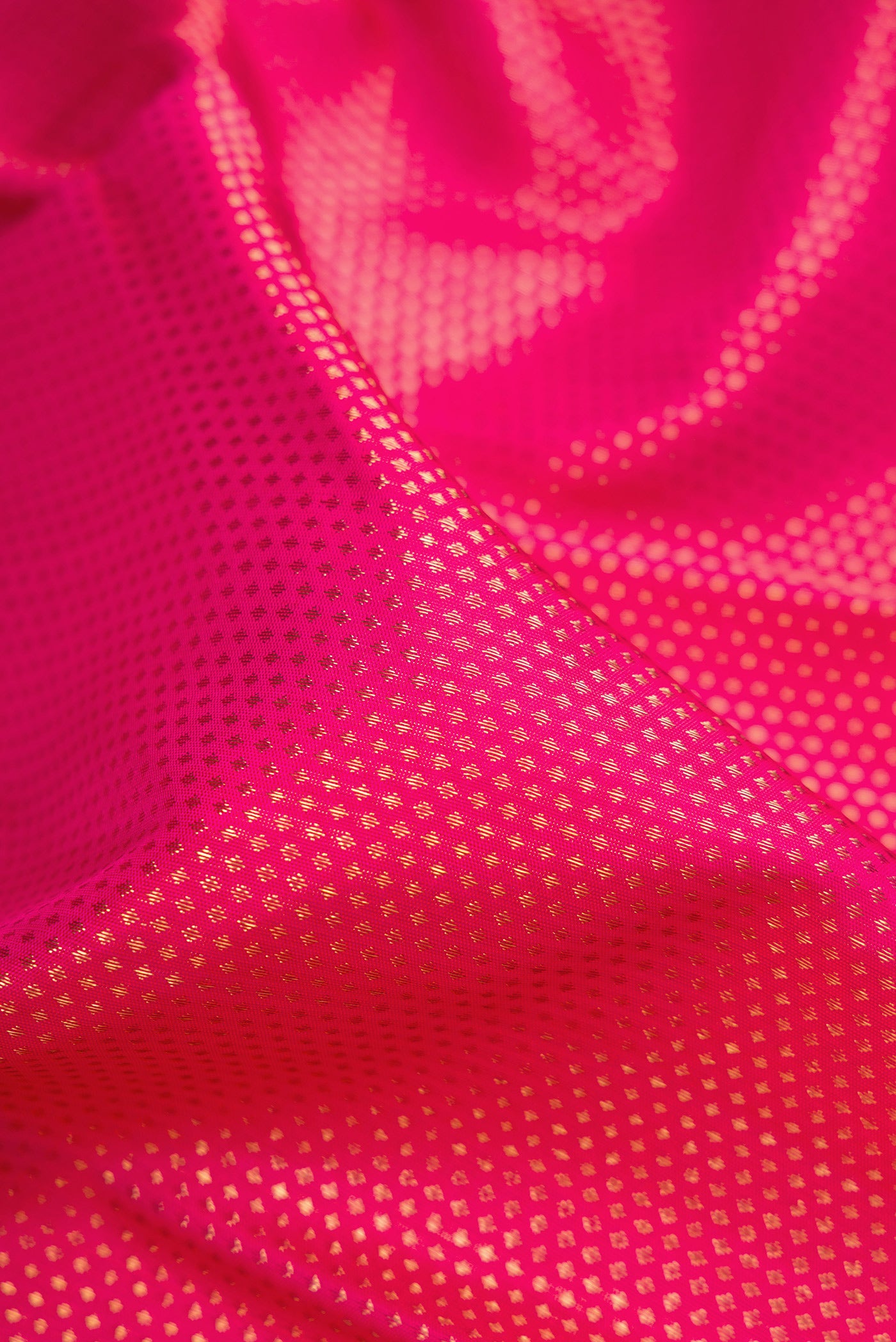 Close up of Pure Silk Pure Zari Pink Dual Tone Kanjivaram Saree with Zari Brocade on the body and Zari Border.  displaying folds