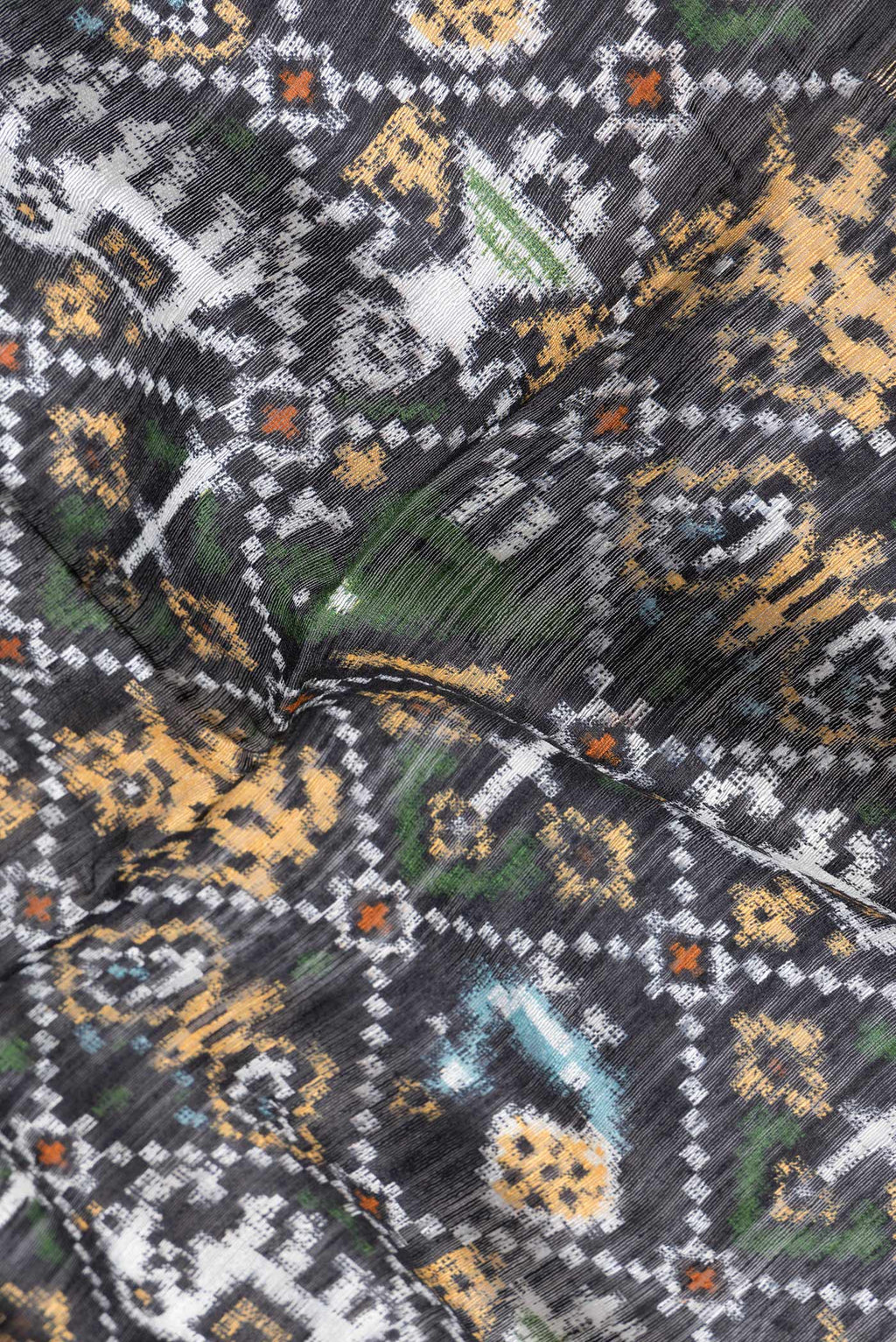 Close up of Black Dual Tone Tussar Silk Saree with Printed design on the body and Zari Border.  displaying folds