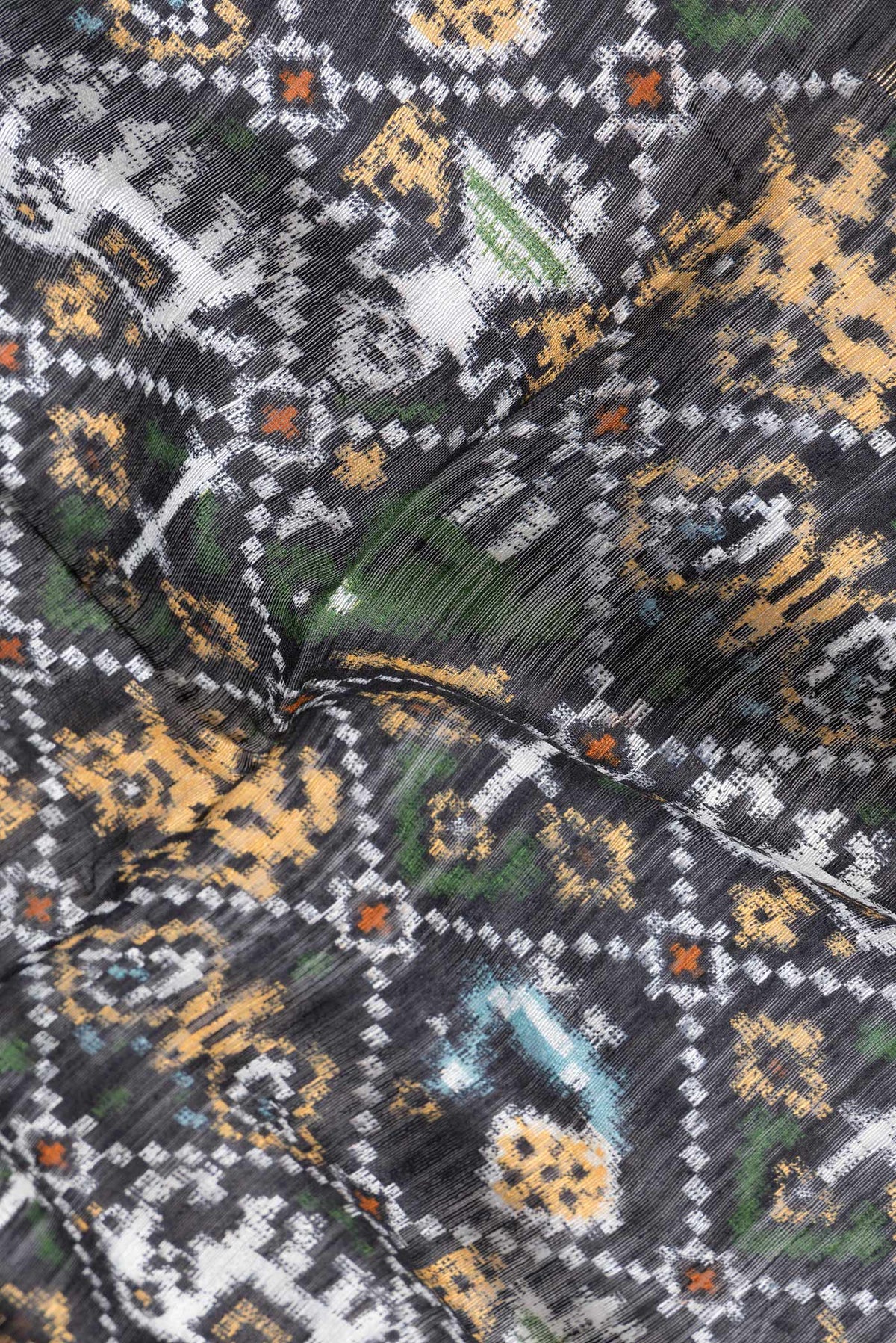 Close up of Black Dual Tone Tussar Silk Saree with Printed design on the body and Zari Border.  displaying folds