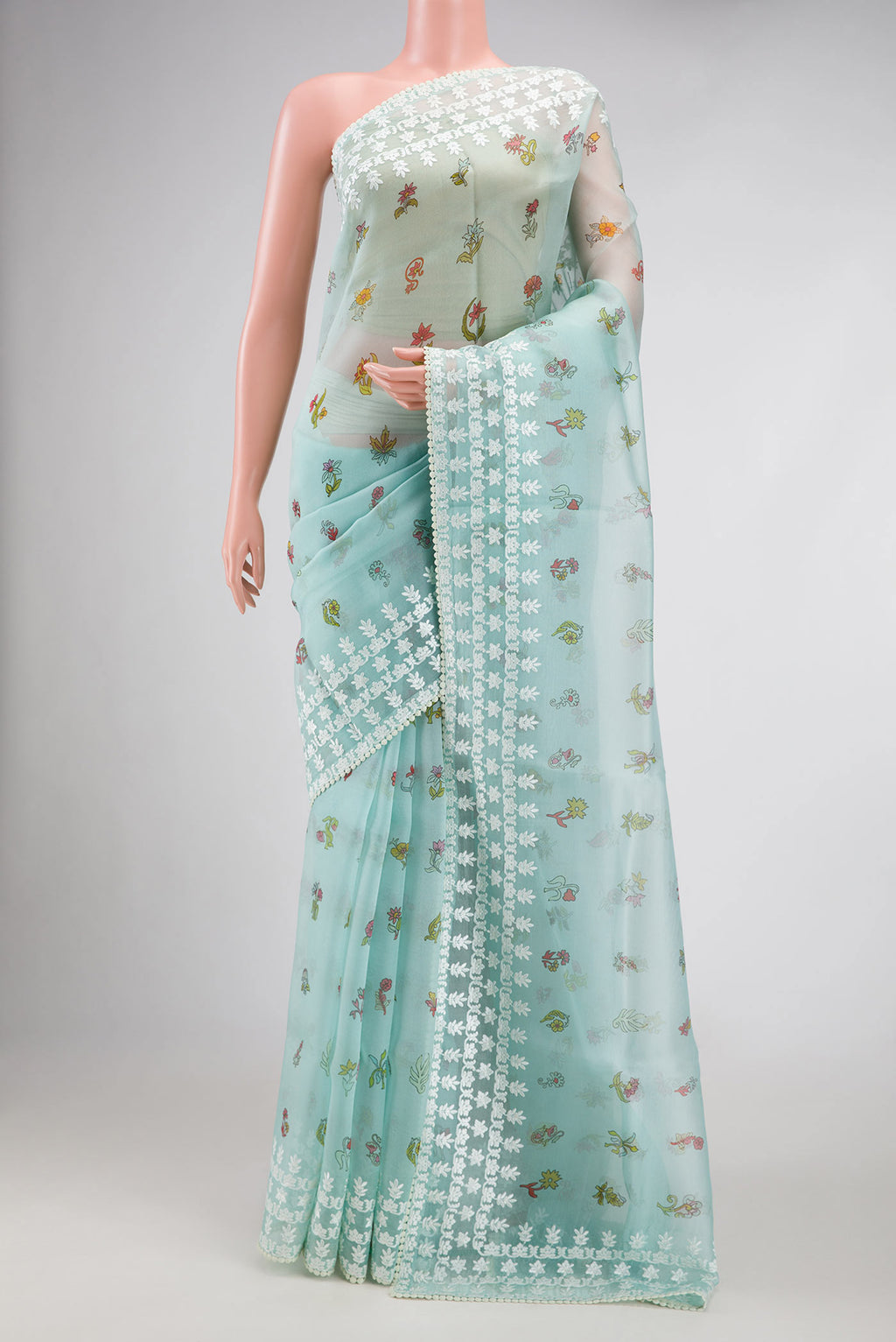 Light Blue Dual Tone Organza Silk Saree with Printed design on the body and Embroidery Border.  displayed on a mannequin