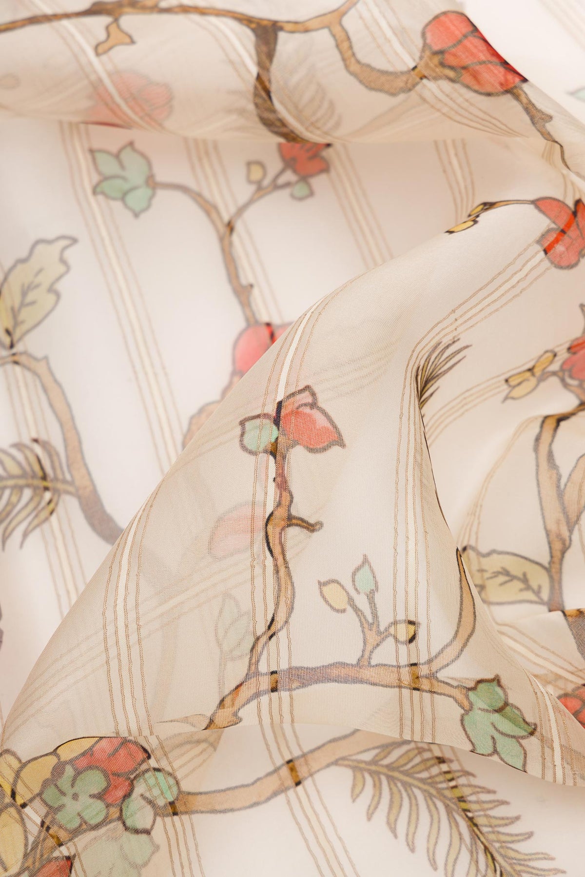 Close up of Beige Dual Tone Organza Silk Saree with Printed design on the body and Fancy Border.  displaying folds