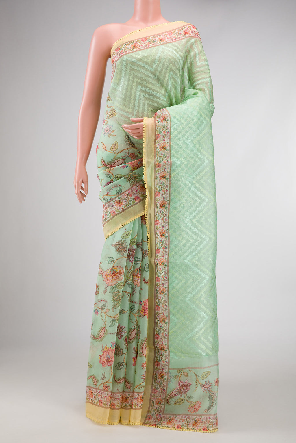 Pista Green Dual Tone Organza Silk Saree with Printed design on the body and Printed Border.  displayed on a mannequin