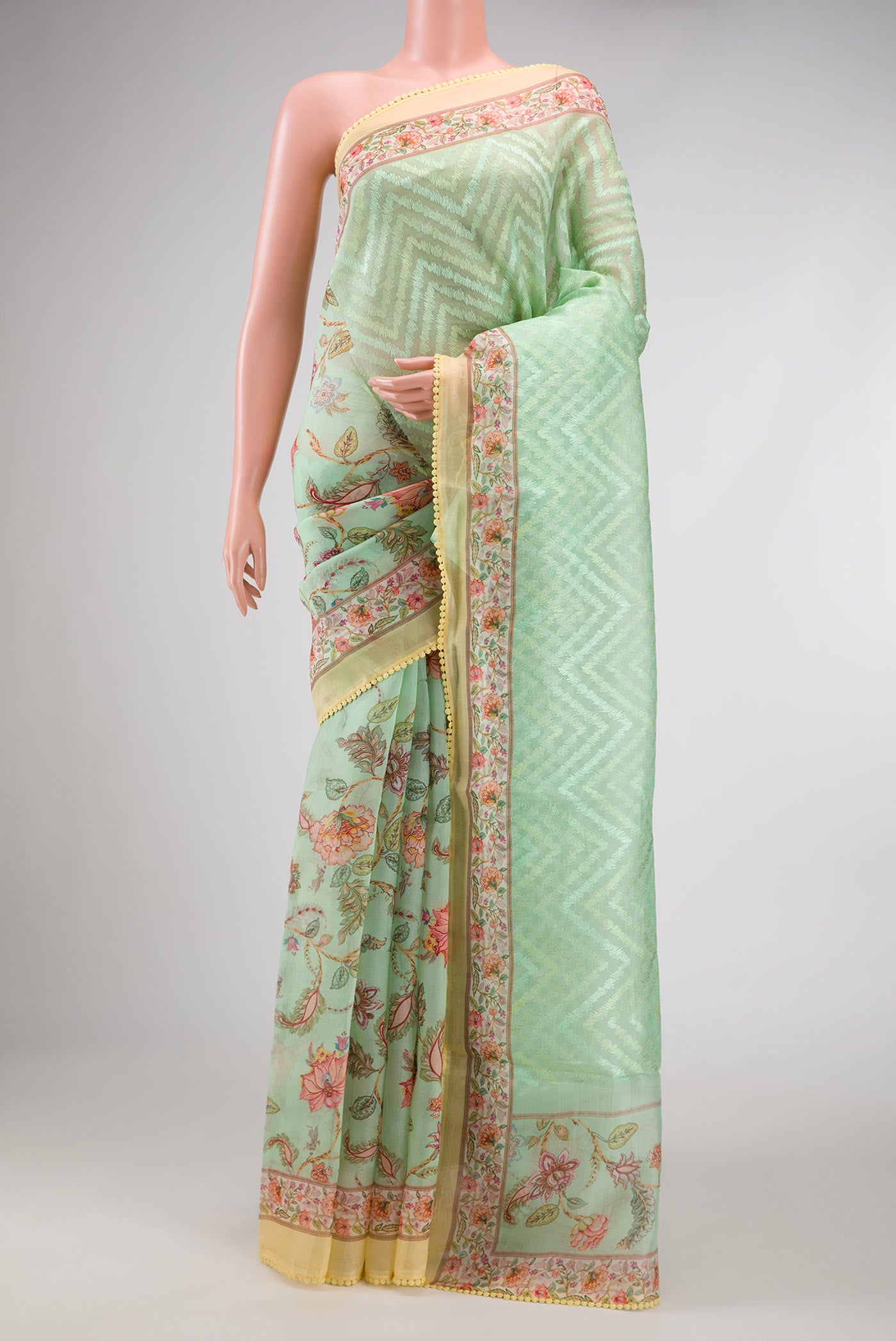 Pista Green Dual Tone Organza Silk Saree with Printed design on the body and Printed Border.  displayed on a mannequin