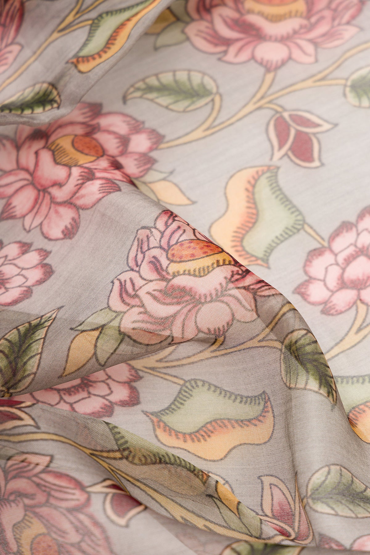 Close up of Grey Dual Tone Organza Silk Saree with Printed design on the body and Embroidery Border.  displaying folds