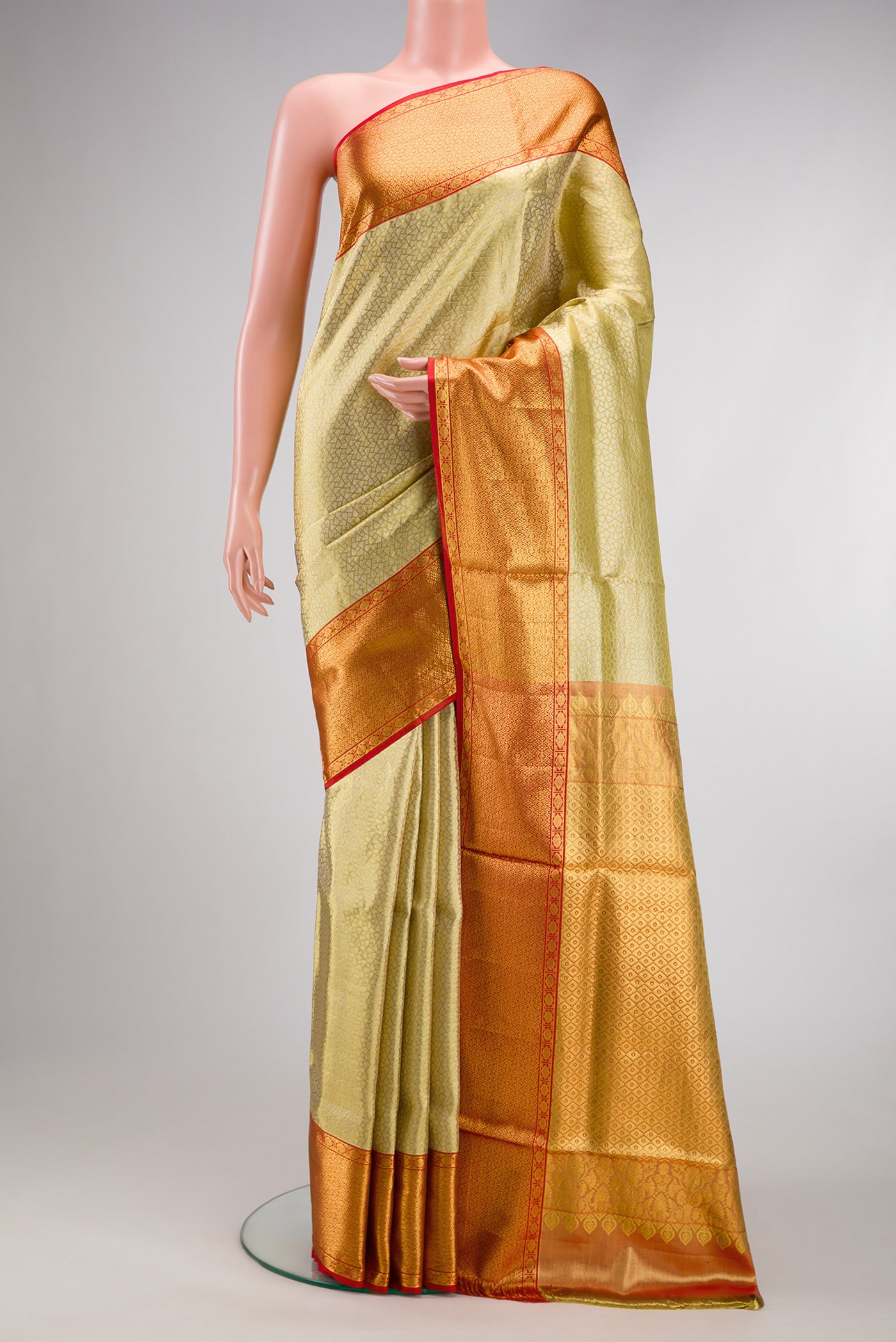 Gold Dual Tone Kanchipuram Tissue Silk Saree with Zari Brocade on the body and Zari Border.  displayed on a mannequin