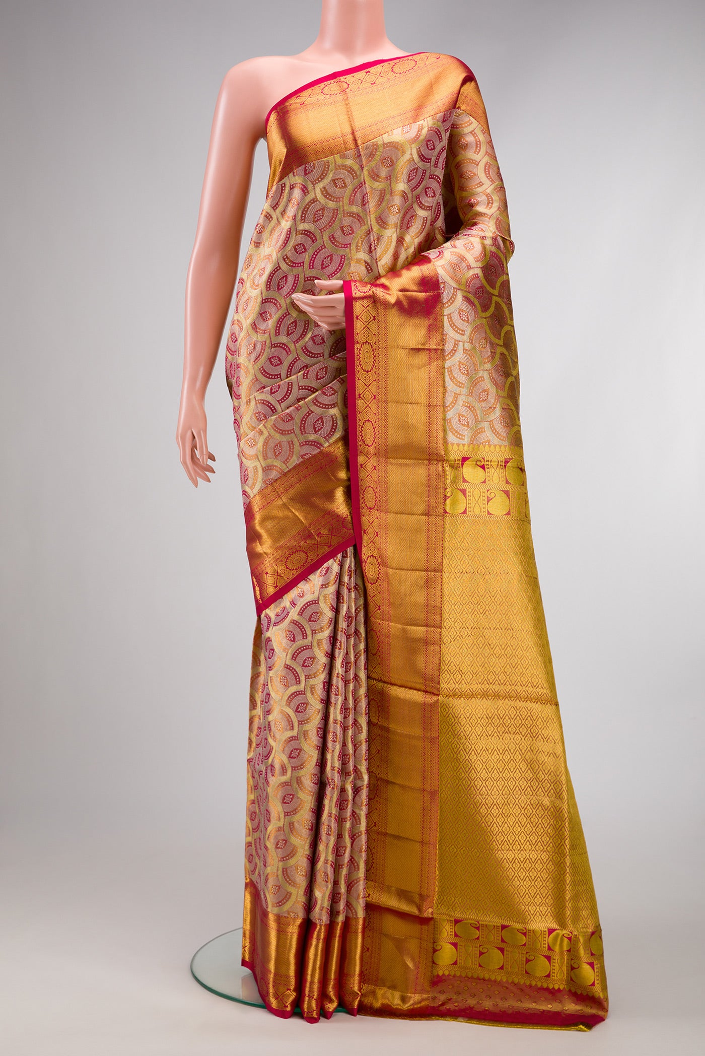 Gold Dual Tone Kanchipuram Tissue Silk Saree with Zari Brocade on the body and Zari Border.  displayed on a mannequin