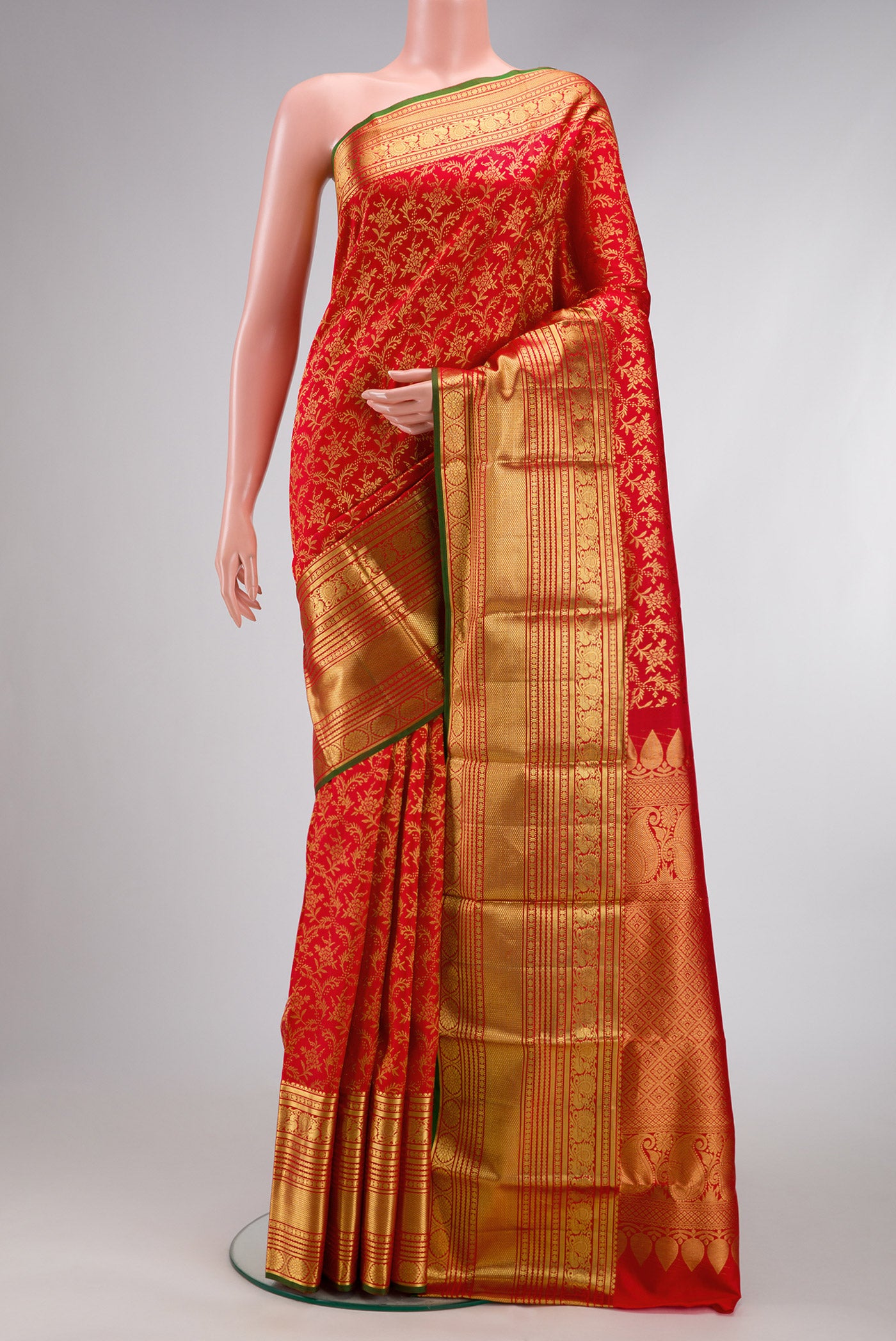 Red Dual Tone Kanjivaram Silk Saree with Zari Brocade on the body and Zari Border.  displayed on a mannequin
