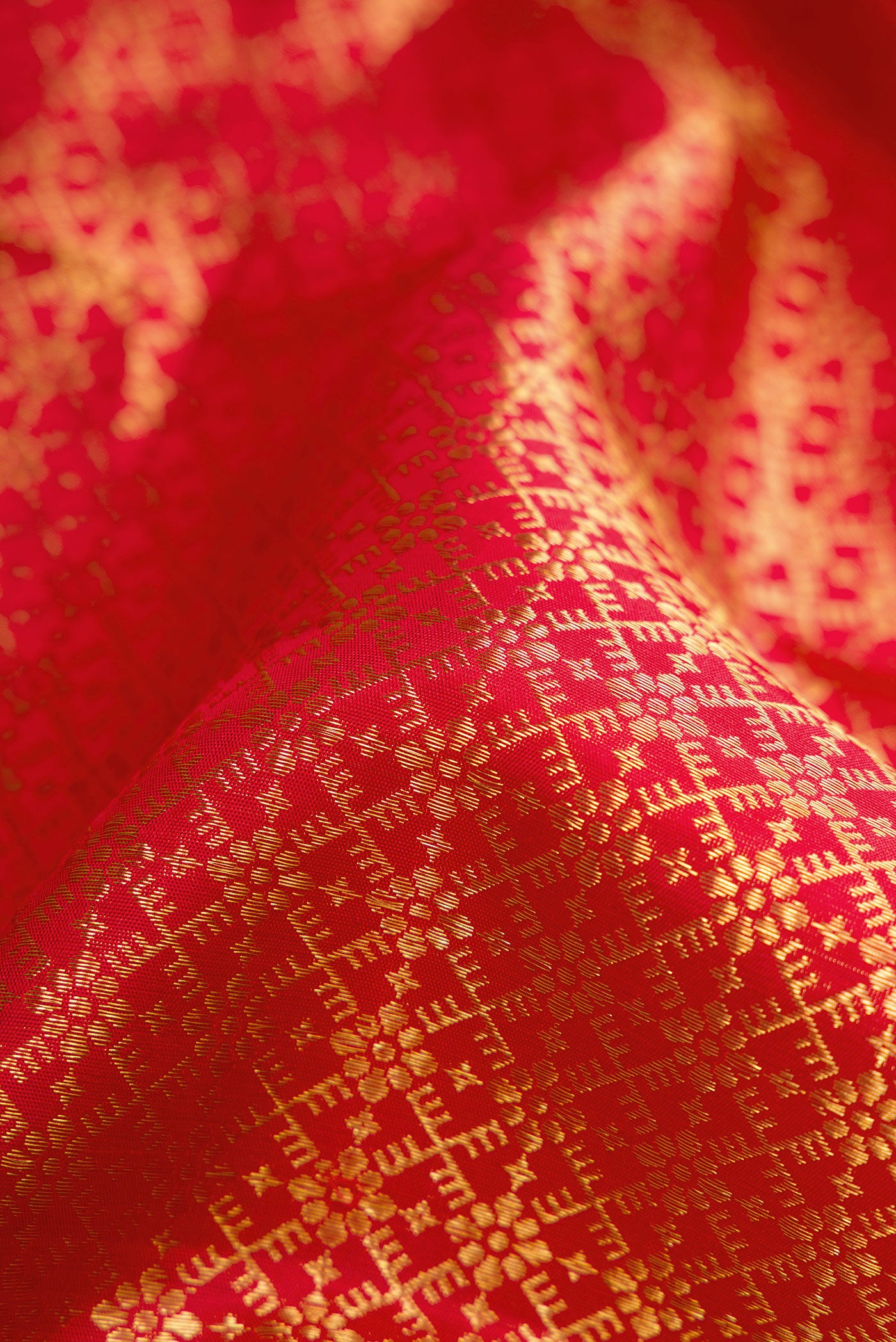 Close up of Red Dual Tone Kanjivaram Silk Saree with Zari Brocade on the body and Zari Border.  displaying folds