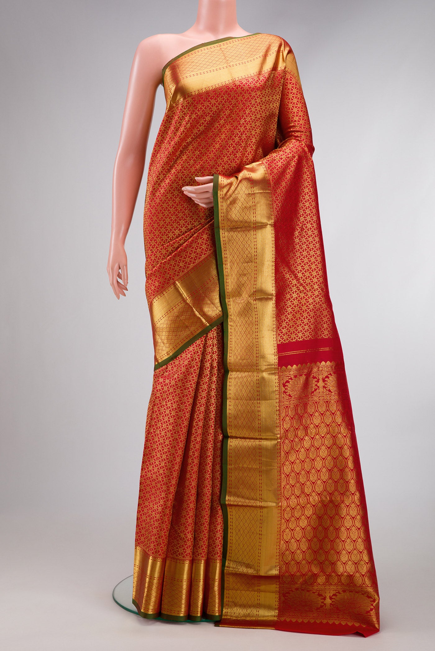 Red Dual Tone Kanjivaram Silk Saree with Zari Brocade on the body and Zari Border.  displayed on a mannequin