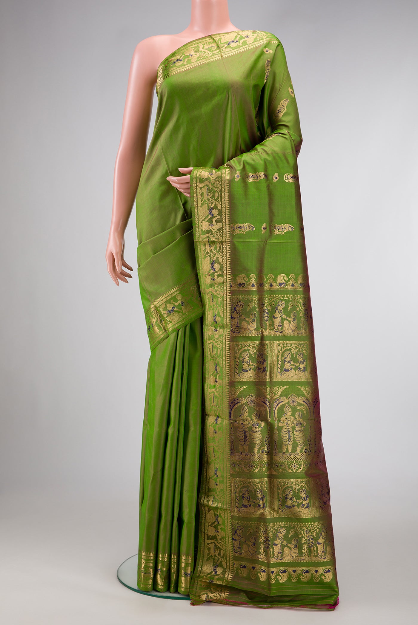 Green Dual Tone Baluchari Silk Saree with Zari And Thread Butta on the body and Zari Border.  displayed on a mannequin