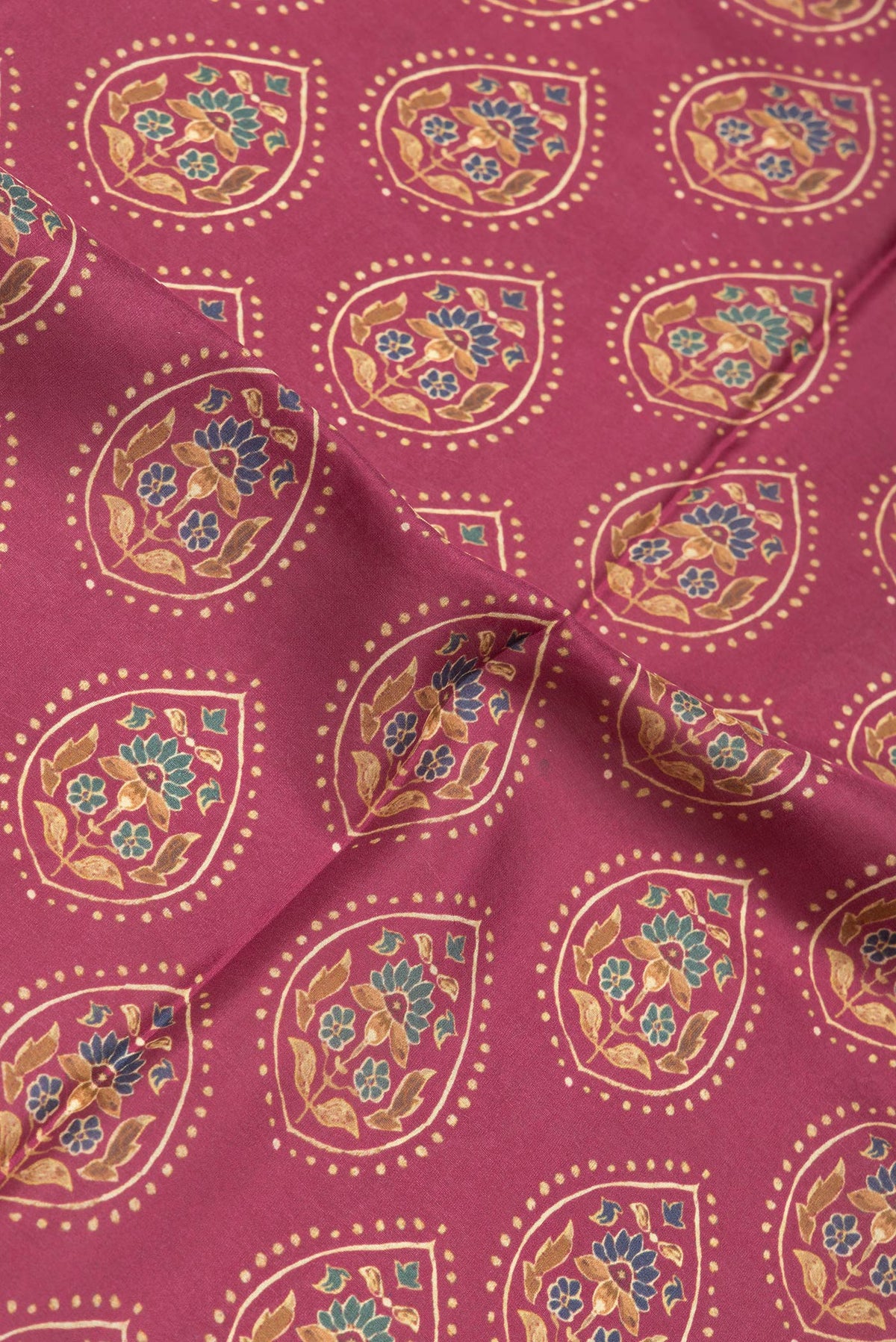 Close up of Maroon Dual Tone Printed Silk Saree with Printed design on the body and Plain Border.  displaying folds