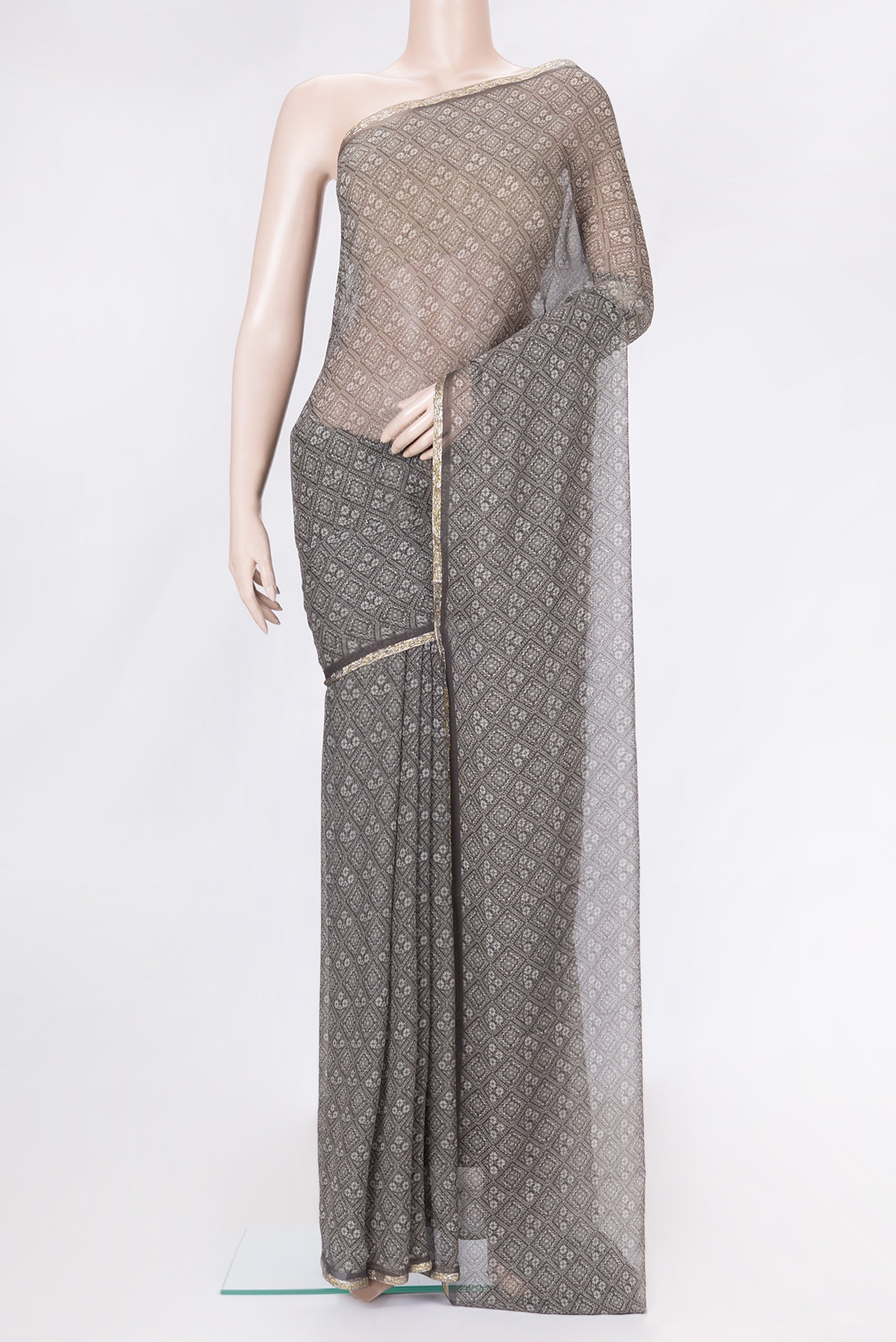 Grey Dual Tone Chiffon Saree with Printed design on the body and Thin Zari Line.  displayed on a mannequin