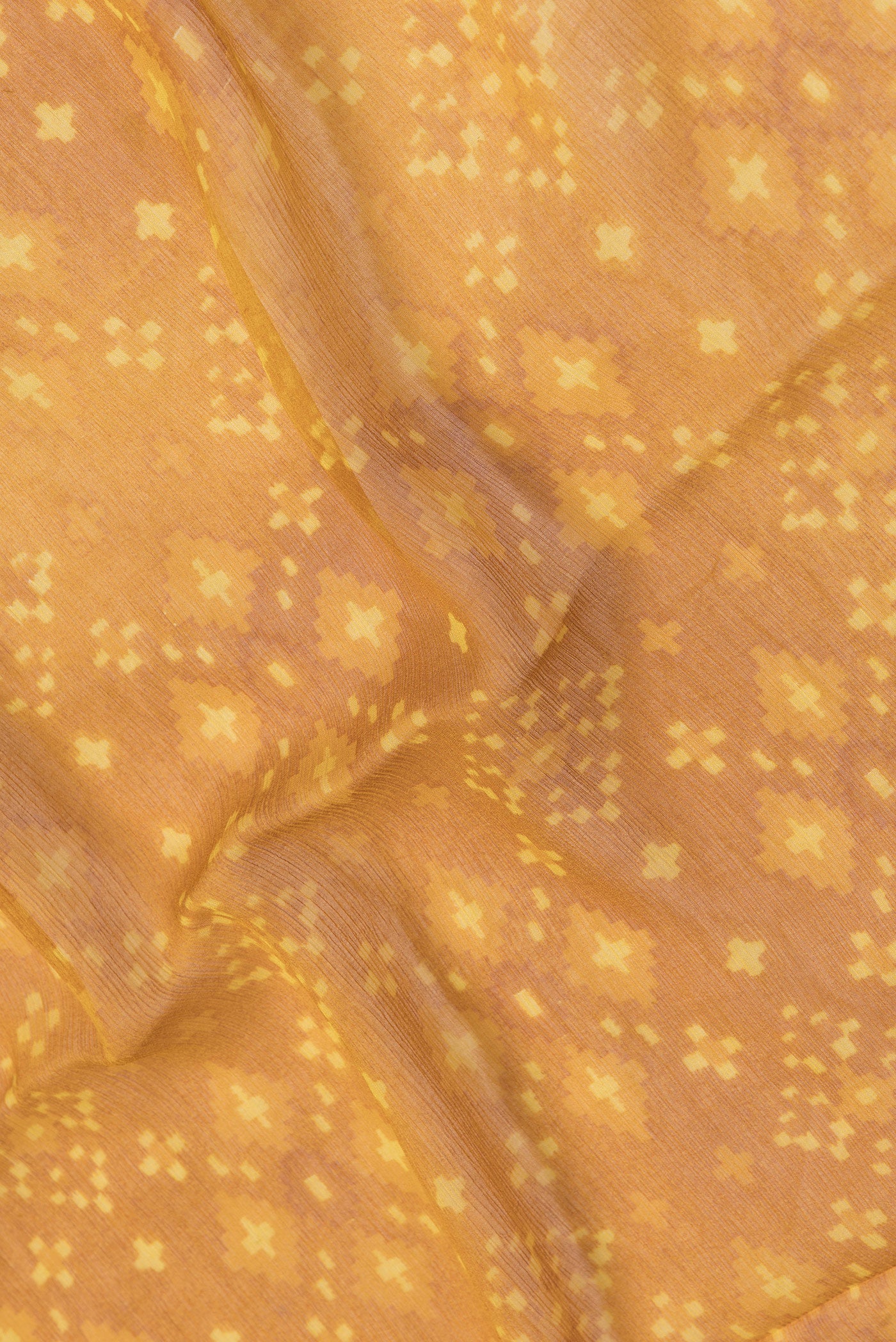 Close up of Mustard Dual Tone Mysore Chiffon Saree with Printed design on the body and Plain Border.  displaying folds