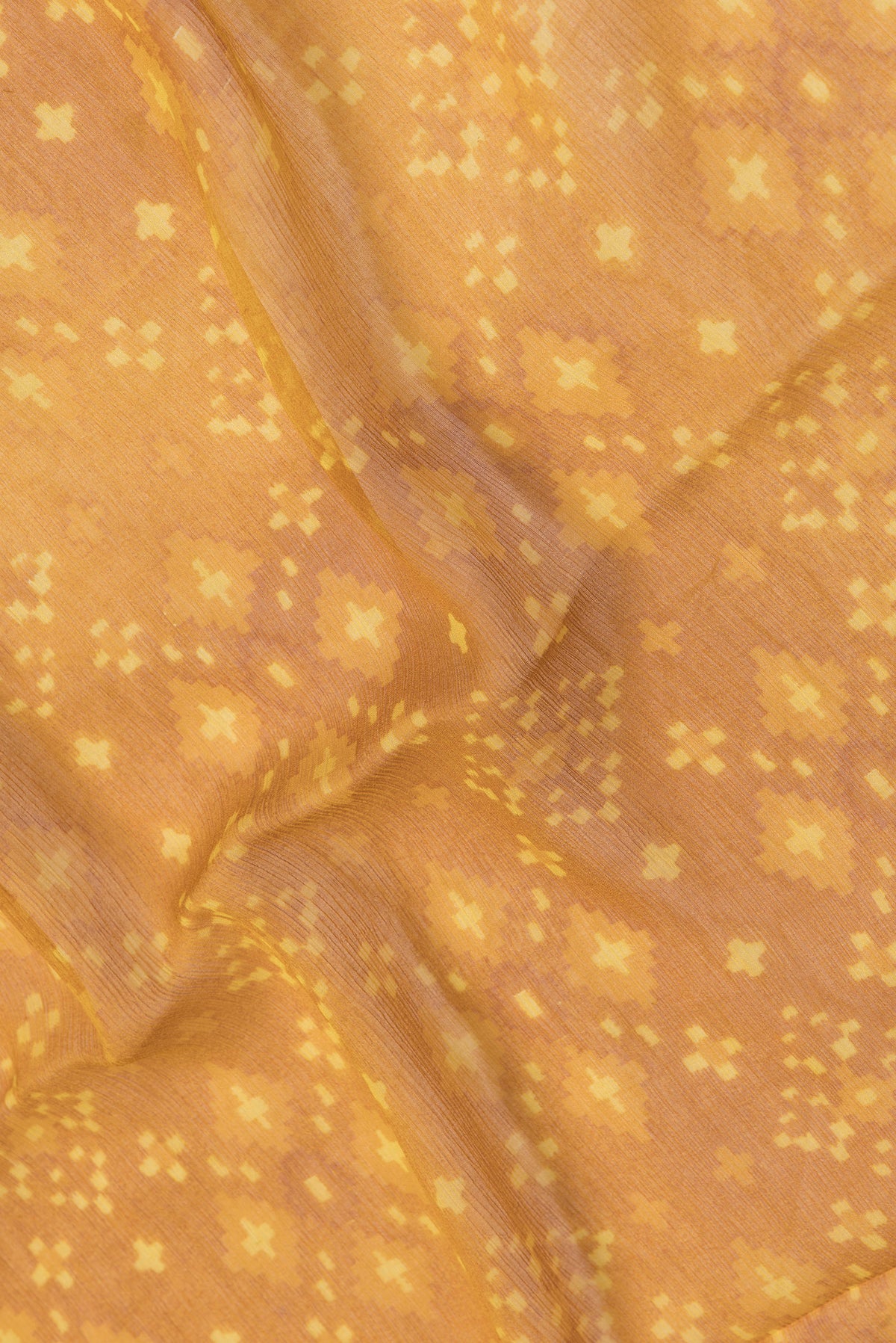 Close up of Mustard Dual Tone Mysore Chiffon Saree with Printed design on the body and Plain Border.  displaying folds