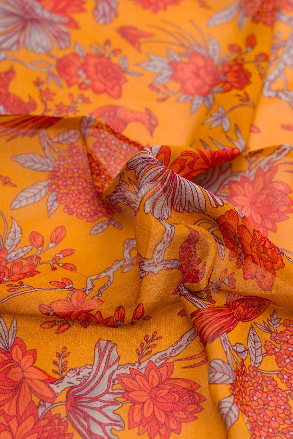 Close up of Mustard Dual Tone Mysore Crepe Saree with Printed design on the body and Zari Border.  displaying folds