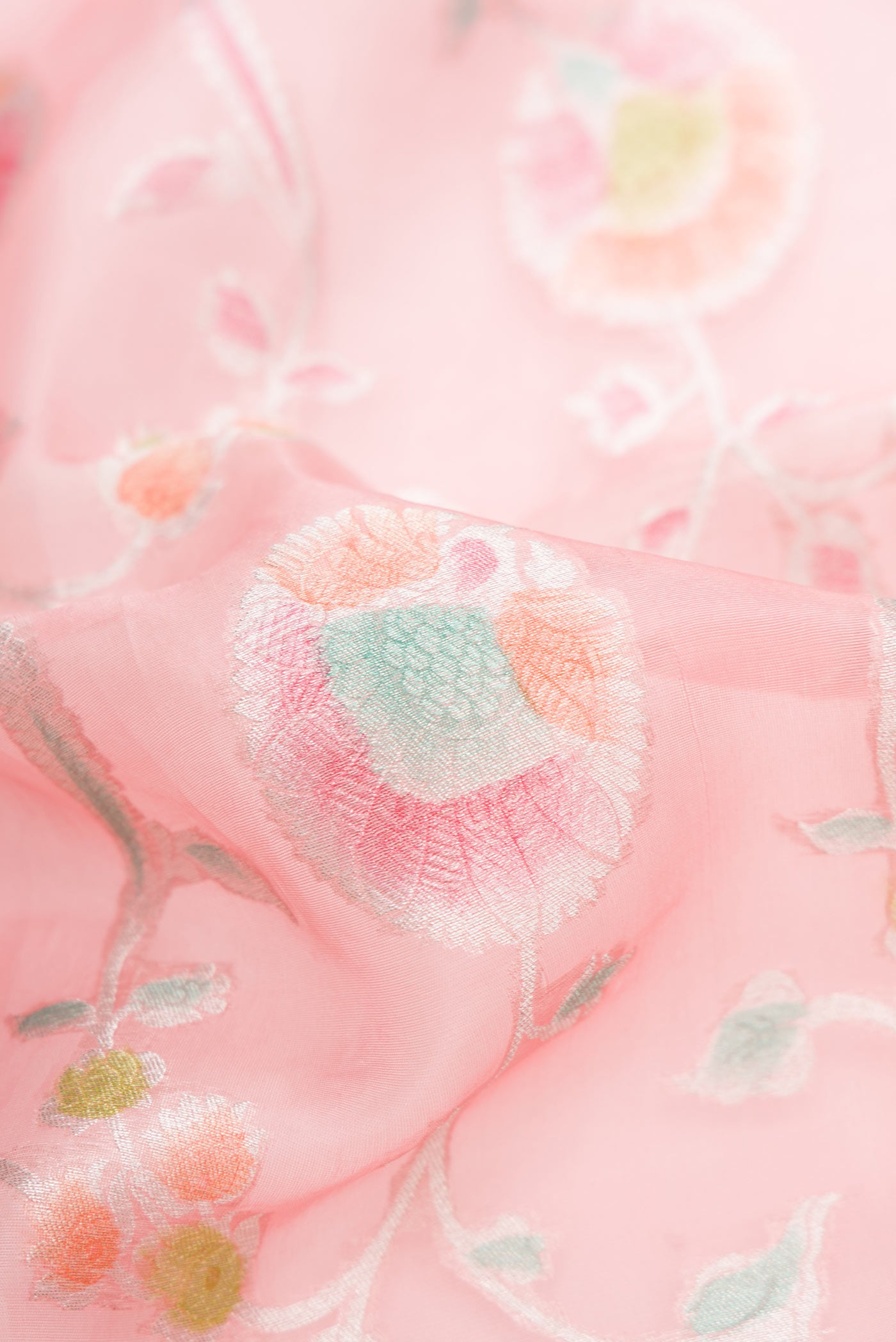 Close up of Pink Dual Tone Organza Silk Saree with Zari Brocade on the body and Zari Border.  displaying folds