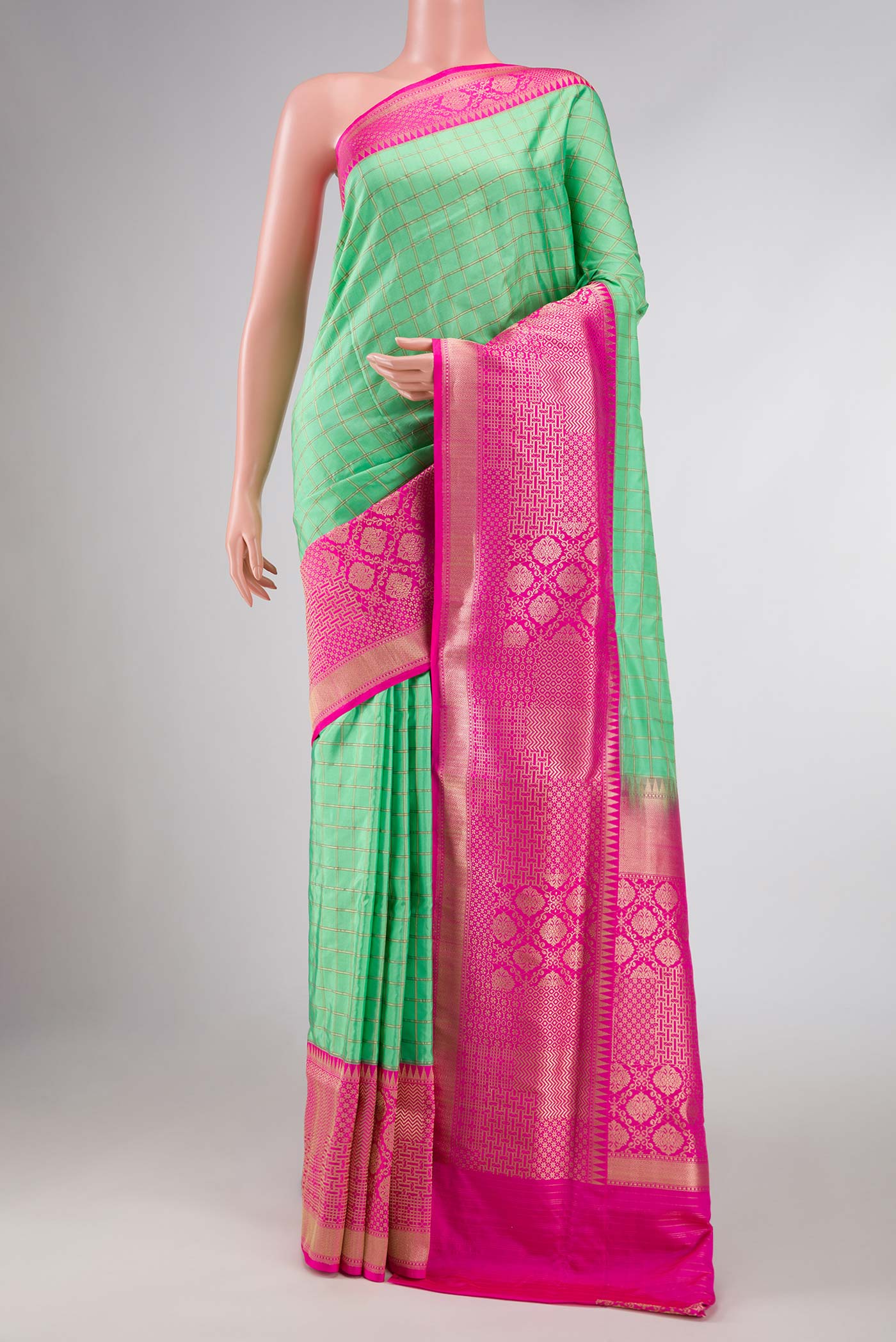 Pure Silk Pure Zari Parrot Green Dual Tone Banarasi Saree with Checked design on the body and Zari Border displayed on a mannequin