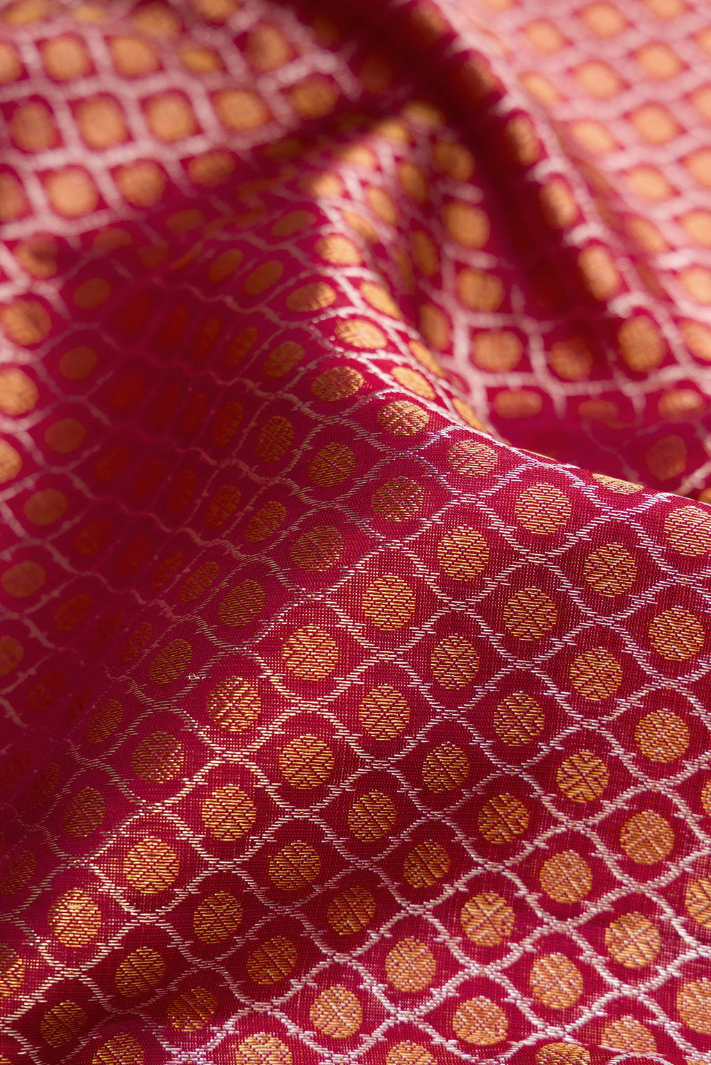 Close up of Maroon Dual Tone Kanchipuram Silk Saree with Zari Brocade on the body and Zari Border.  displaying folds