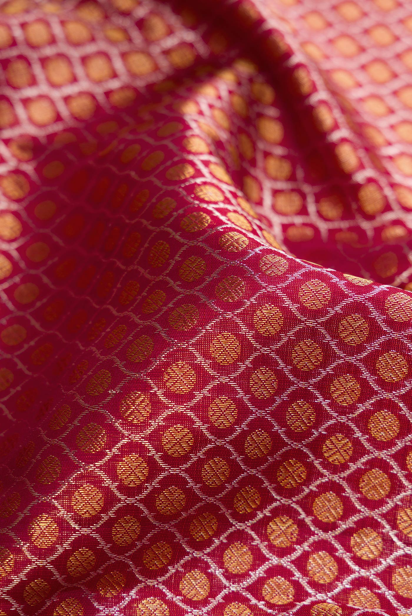Close up of Maroon Dual Tone Kanchipuram Silk Saree with Zari Brocade on the body and Zari Border.  displaying folds