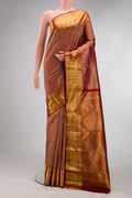 Maroon Kanchipuram Silk Saree with Zari Brocade on the body and Zari Border.  displayed on a mannequin