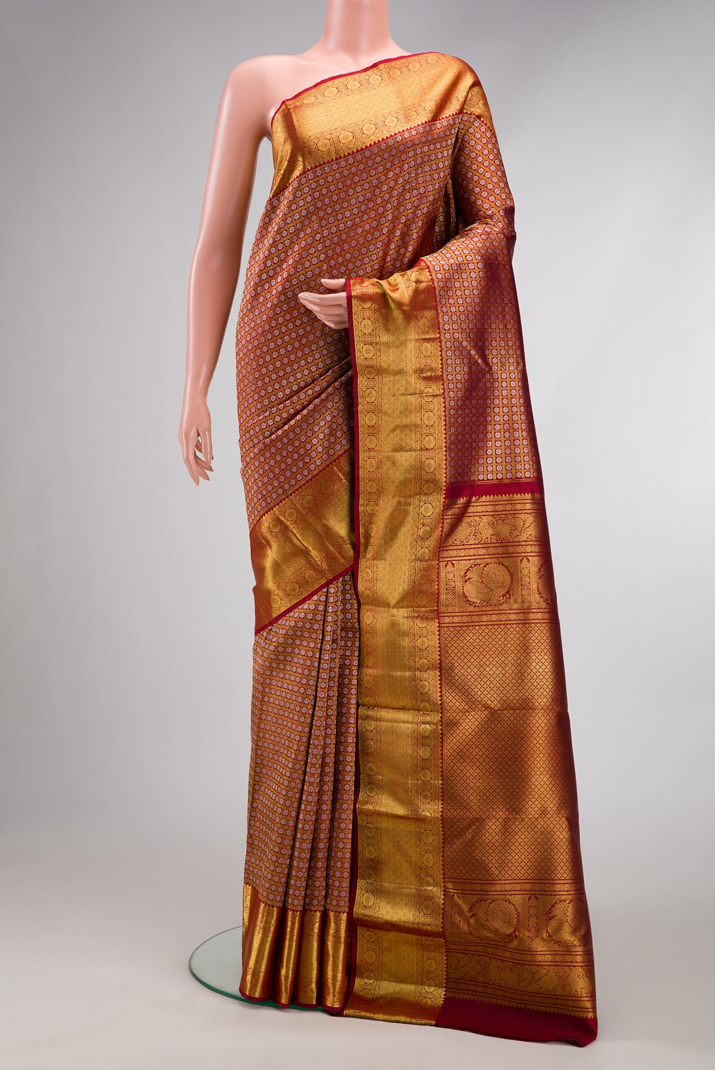 Maroon Kanchipuram Silk Saree with Zari Brocade on the body and Zari Border.  displayed on a mannequin