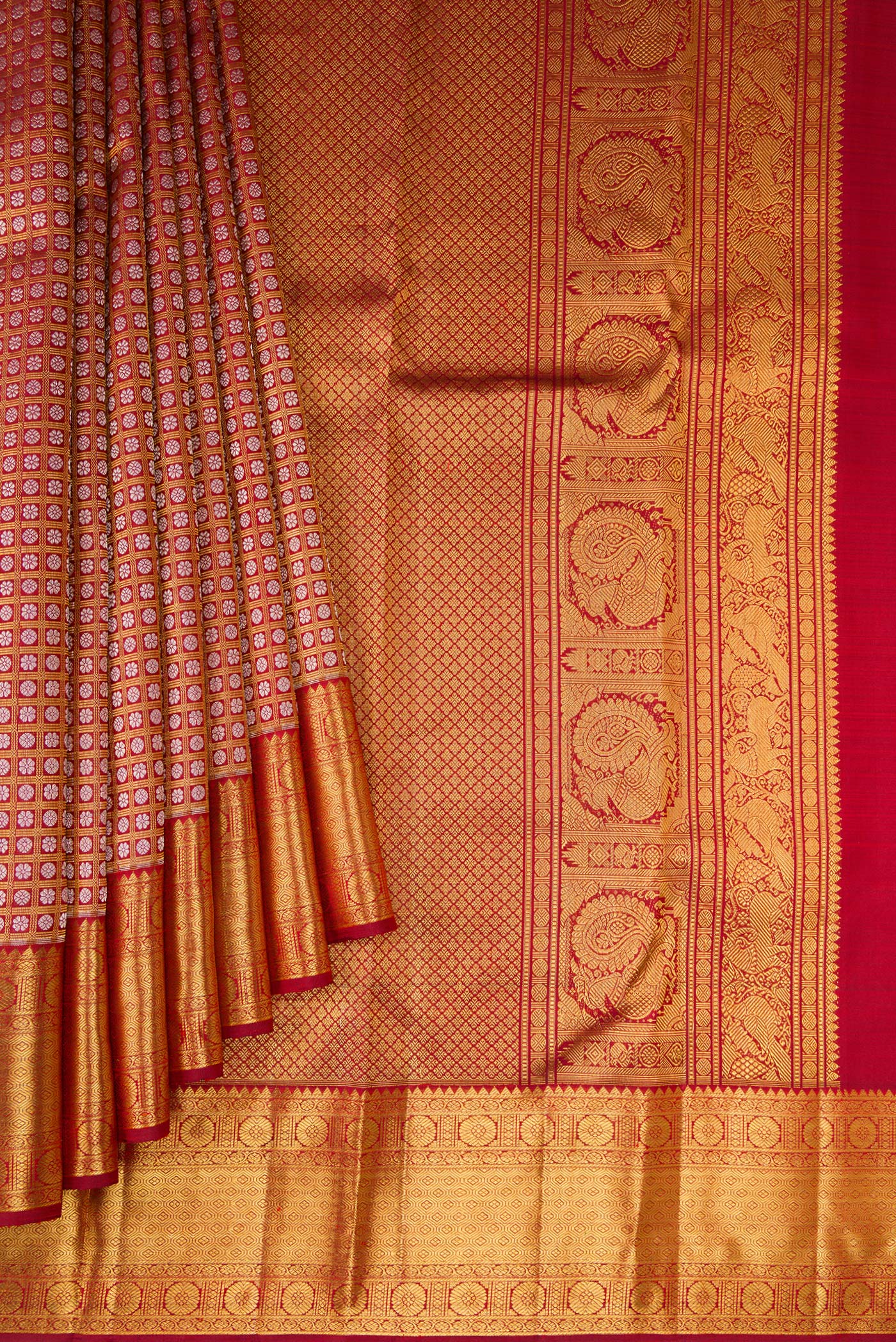 Pleats and pallu of Maroon Kanchipuram Silk Saree with Zari Brocade on the body and Zari Border. 