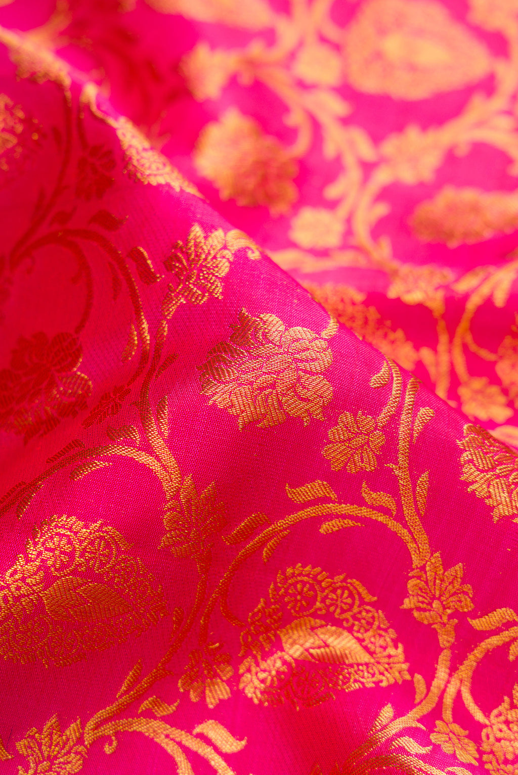 Close up of Pink Dual Tone Kanjivaram Silk Saree with Zari Brocade on the body and Zari Border.  displaying folds